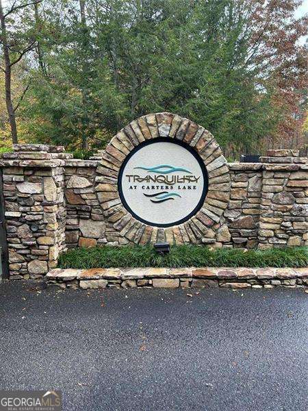 Corner Lot 184 in Tranquility at Carters Lake - Ready to Build! Ellijay, GA (Gilmer County) Discover the perfect canvas for your dream home in the highly sought-after Tranquility at Carters Lake community! This prime corner lot is ready for you to build on and comes completely with underground utilities, public water, and electricity readily available. There is also a fire department just outside of the gate, and two fire hydrants feet from the property, which could get you better insurance rates. This gated community offers all paved roads, nature trails, a playground, and a pavilion area. All of this makes it easier to start your next chapter in the beautiful North Georgia mountains. Enjoy access to Carter's Lake Boat Ramp-just minutes away-for endless days of fishing, boating, and outdoor fun. Need storage? Convenient dry boat storage units are also available nearby, making lake life hassle-free. Nestled in nature yet only minutes from downtown Ellijay, and 70 miles north of Atlanta. You'll have the best of both worlds: peaceful mountain living with quick access to shopping, dining, and entertainment, and close enough to Atlanta to enjoy a day trip! Don't miss this rare opportunity to build in one of Ellijay's premier lake communities. Whether you're planning a full-time residence or a weekend retreat, this lot offers the serenity, space, and lifestyle you've been searching for! Location: Tranquility at Carters Lake, Ellijay, GA https://tranquilityatcarterslakeownersassociation.com/ Lake Access Boat Storage Underground Utilities Scenic Surroundings Your mountain getaway begins here!