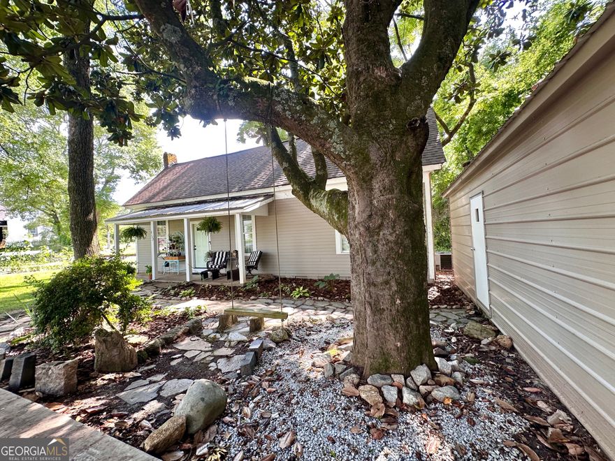 Cute cottage on Collins Street, right in downtown Covington! This adorable 2 bedroom, 1 bathroom home has been recently renovated with new cabinets and countertops in kitchen, fresh paint throughout, refinished flooring, new light fixtures, new appliances and more! NEW ROOF in 2024! Covered front porch with metal roof shaded by a beautiful and historic magnolia tree with swing. Large metal garage building for ample storage.