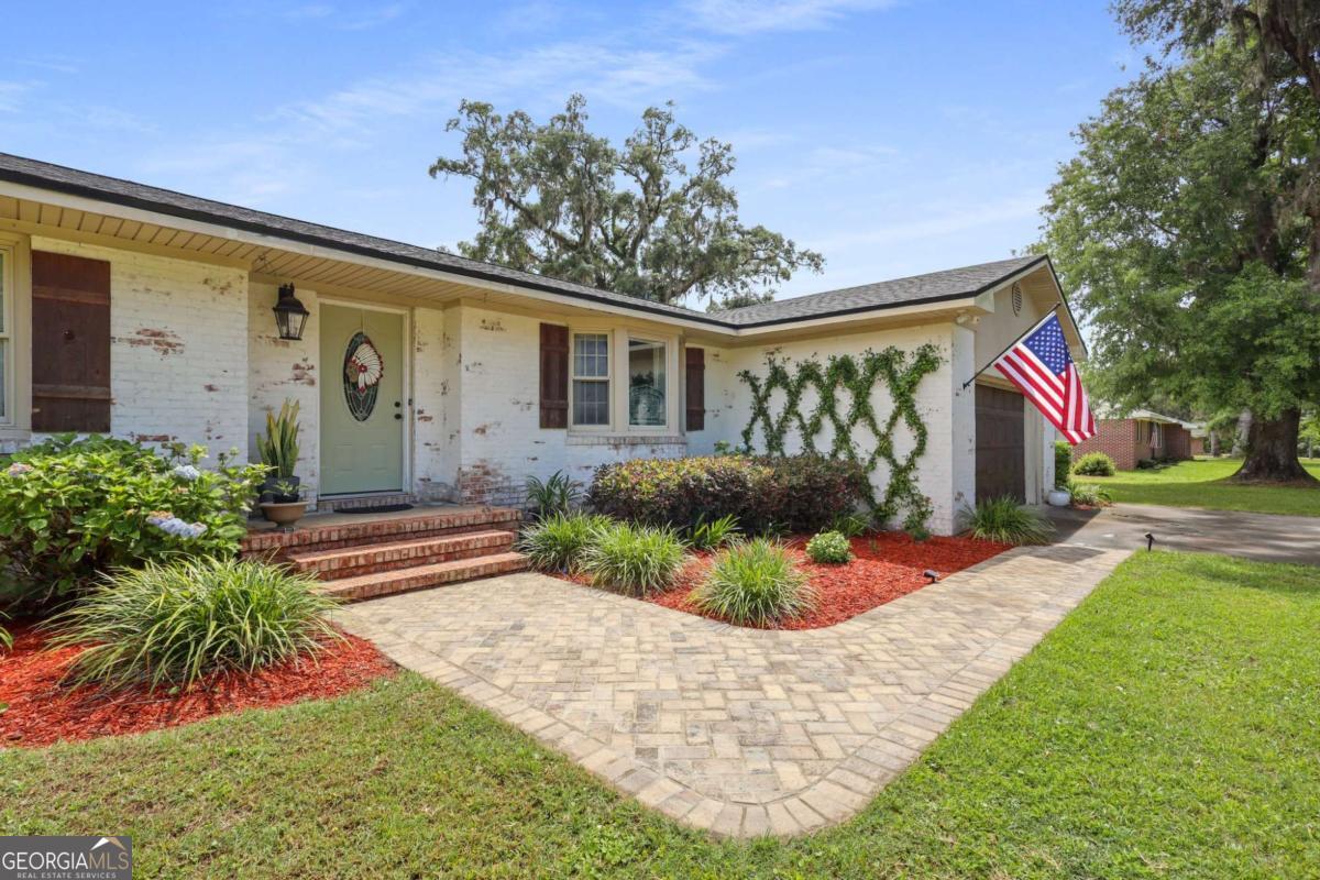 Discover timeless elegance and modern comfort in this beautifully updated 3-bedroom, 2-bath home. From rich hardwood floors and designer lighting to custom tile work and high-end wallpaper accents, every detail has been thoughtfully curated to add character and style. Situated on a generous double lot, this property offers endless possibilities-whether you envision adding a pool, creating a lush garden, or fencing it in for pets. A 24x24 detached garage provides ample space for storage, hobbies, or parking. Step inside to a bright and welcoming living room that opens effortlessly into an expanded kitchen and stylish dining area-ideal for both entertaining and everyday living. The kitchen is a true showstopper, featuring crisp white cabinetry, stainless steel appliances, a spacious island with bar seating, and a layout designed for both beauty and function. Unwind in the evenings on the screened-in back porch, perfect for enjoying peaceful sunsets or morning coffee. This move-in ready home offers the perfect blend of warmth, sophistication, and practical living. Don't miss your opportunity-schedule your showing today!