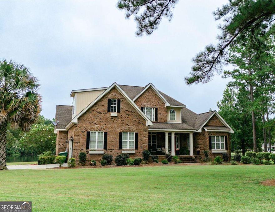 20 Ray Taylor Rd, Tifton, GA 31793  Welcome to Taylor Ridge Estates! This 3,581 square foot executive home offers elegance, space, and comfort on a beautifully landscaped 1.07-acre lot.    Step inside and be greeted by heart pine floors flowing throughout the main level. The living room features soaring 18-foot ceilings, a cozy gas fireplace with a stone mantle, and expansive windows that flood the home with natural light. The chef's kitchen is a dream-complete with custom cabinetry, granite countertops, double ovens, breakfast bar with stools, and an adjoining breakfast nook for casual meals. A formal dining room provides the perfect setting for family gatherings and entertaining.    The luxurious master suite is located on the main floor, offering a spacious retreat with a tiled walk-in shower, glass doors, his-and-hers sinks, and a deep soaking tub. Upstairs, you'll find three additional bedrooms and two full bathrooms. One bedroom is oversized and easily doubles as a family room or flex space.    Enjoy peaceful evenings on the screened-in back porch overlooking the lake and fenced backyard. A two-car garage plus an additional brick storage shed provide ample storage and convenience.    With 5 bedrooms, 4.5 bathrooms, and over an acre of land, this home blends luxury and functionality in one of Tifton's most sought-after neighborhoods.     Don't miss this opportunity! Call today to schedule your private showing.