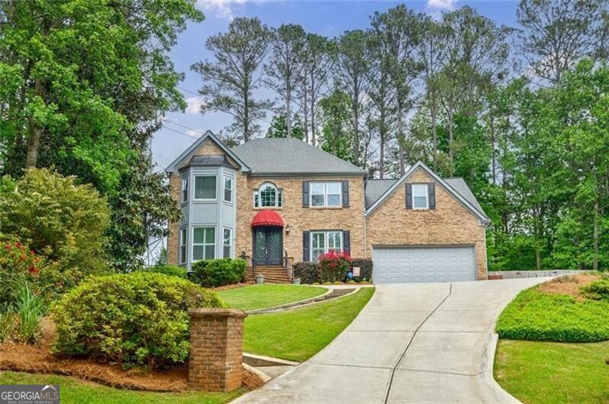 Welcome home to this well maintained 5-bedroom, 3.5-bath home in Robinson Farms, a sought-after swim/tennis community in the prestigious Walton High School district. Nestled on a cul-de-sac lot, this three-sided brick beauty offers timeless elegance and modern comfort. The updated kitchen features stainless steel appliances, granite countertops, glass backsplash, wine rack, a breakfast bar, and a dining area that flows seamlessly into the keeping room, complete with a cozy fireplace. The main level also boasts a formal dining room, a dedicated office, and a sunroom, perfect for relaxing in natural light. Upstairs, the spacious primary suite includes a sitting area with office/ flex space, a large walk-in closet, and an exquisite ensuite bath with a designer tub, glass shower, tile flooring, and dual vanities. Three additional bedrooms and a beautifully appointed bath complete the upper level. The terrace level has a bedroom with full bath and is designed for entertaining, with ample space for a gym, pool table, or casual gatherings. Outdoors, the private fenced-in backyard is a true retreat, featuring a putting green, a patio perfect for grilling, and a serene dining area for al fresco meals. Also featuring hardwood flooring, new double pane windows, plantation shutters, powder room with designer sink, built-in bookcases, insulated garage door, low HOA fees. Conveniently located near Fuller's Park, shopping, and dining, this home is the perfect blend of elegance, comfort, and accessibility. Don't miss the opportunity to make it yours!