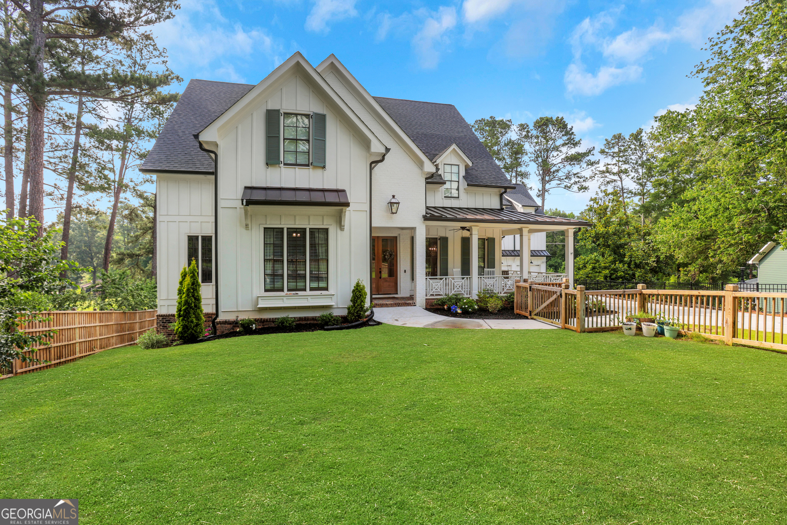Perfectly positioned in the heart of Indian Hills and zoned to the top-rated Walton High School, this exceptional custom-built home combines timeless architecture with today's most desirable features. Built in 2020 and filled with high-end upgrades, this residence offers an unmatched lifestyle of comfort, sophistication, and thoughtful design. From the moment you enter, a stunning formal dining room sets the tone with refined elegance. Continue into the vaulted chef's kitchen, outfitted with top-of-the-line appliances, an oversized island, walk-in pantry, stylish wet bar, and charming built-in breakfast nook. The kitchen flows effortlessly into the coffered-ceiling living room, where a cozy brick fireplace and French doors open to a covered Trex deck with sweeping views of the Indian Hills golf course-ideal for outdoor dining or relaxing year-round. The main-level primary suite serves as a peaceful retreat, featuring a sitting area, fireplace, spa-inspired bathroom with soaking tub, walk-in shower, and dual custom closets. A separate office or playroom on the main floor offers flexibility for your lifestyle needs, whether working from home or creating a creative space for the kids. The spacious mudroom and large laundry room add practical convenience to everyday living. Tucked away with its own private entrance, the au pair or in-law headquarters provides incredible flexibility. Complete with a full bathroom, living room, and separate bedroom, this self-contained suite is ideal for extended guests, multigenerational living, or a private home office setup. Upstairs, you'll find a second luxurious primary suite with a sitting area, marble bathroom, and dual closets, along with two additional ensuite bedrooms, a second laundry room, and a cozy built-in reading nook. The finished terrace level is designed for entertaining and easy living, featuring a full second kitchen, expansive open living area, home gym, office, and private guest suite. Step outside to a terrace-level patio upgraded with brand new turf, creating the perfect spot for outdoor lounging, play, or entertaining. With its premium golf course location, luxurious finishes, and incredibly functional layout, this home truly checks every box. Don't miss the opportunity to experience East Cobb's finest. Schedule your private showing today and fall in love with every detail.