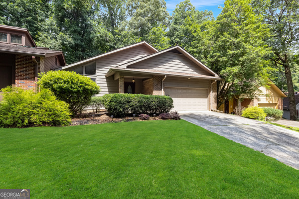 Live in a neighborhood that has it all! 4 Pools, 16 tennis courts, 2 Pickleball courts a 55 acre lake for canoeing and fishing, and trails to the Chattahoochee River. This townhome has vaulted and beamed ceilings, Luxury vinyl plank flooring, new lighting, new kitchen appliances, fresh paint and more. Family room with cozy fireplace and wet bar, sliding glass doors to the expansive deck overlooking a wooded backyard. Kitchen has tile floors, a walk-in pantry and granite counters. Full size laundry room. Formal dining room with 2 story ceiling. Upstairs you will find 3 bedrooms, the primary suite has a balcony window, updated bath and walk-in closet. The dedicated office has skylights and built in cabinetry too. The two car garage has a work bench and beverage refrigerator. Easy access to Roswell Rd and Ga Hwy 400. Great shopping at nearby North Point Mall and the Greenway. True resort living! Owner is a licensed Realtor.