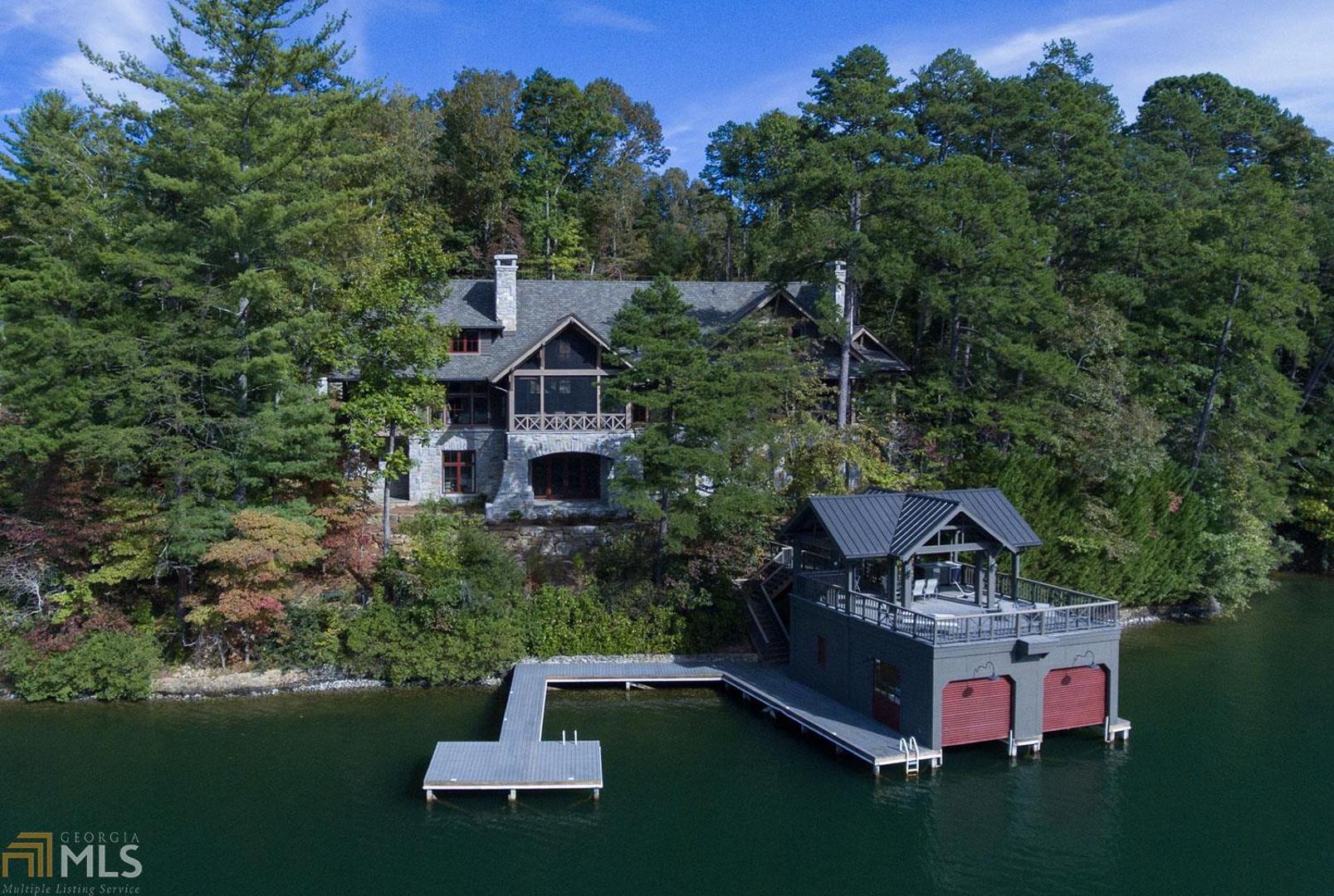 Designed by PRITCHETT+DIXON architects, this expertly crafted 6 BD, 7 fb and 2 hb Lake Burton home was completed in 2018. Built as a contemporary Timber Frame Lodge with cypress timbers and granite stone, the clean-lined interior features custom mill-work and ship lap paneling. Westerly views of the lake and distant mountains are enjoyed throughout the home. The main floor owner’s suite offers a lakeside porch and spa-like bath. Four additional guest suites plus a bunk room provide ample room for guests. Amenities include professional appliances, elevator, nanawalls, generator, 2-car garage and 2-story boathouse.