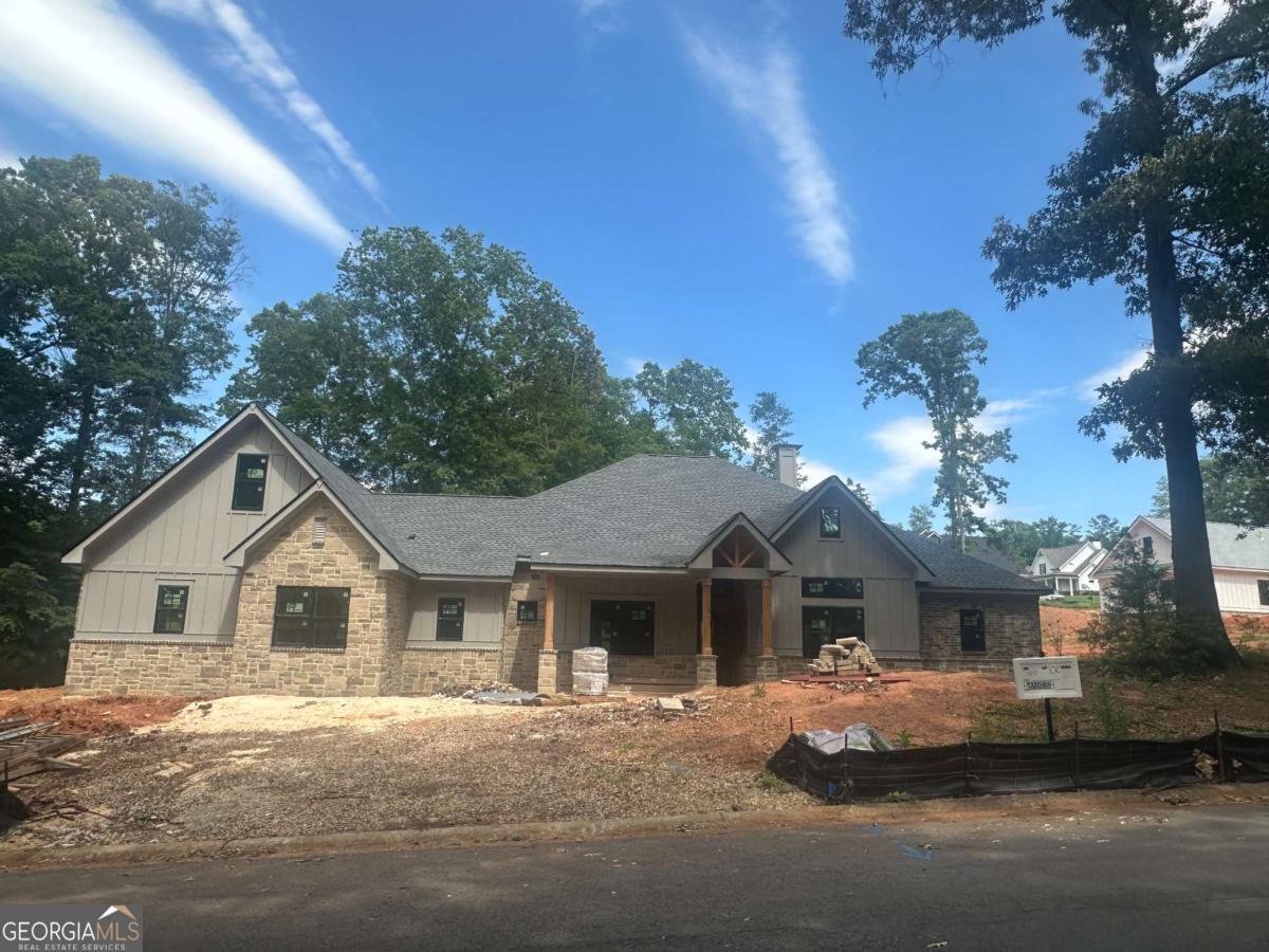 Custom-built designs in the well-established community of Sandy Creek. A golf course community in North Jackson County, close to Athens. This executive design provides an open floor plan, vaulted beamed ceilings, and a separate game room that opens to the impressive covered porch. The main floor also offers 10" ceilings, a study, a separate dining area, accent walls, wood flooring, a chef-inspired gourmet kitchen with quartz counters, pot filler, white and stained cabinets, a large island, double ovens & more. The 4 bedrooms, 3.5 baths on the main floor with one of the 4 bedrooms having an en suite, and the other 2 secondary bedrooms enjoy a jack and jill bath. The primary suite is located on the opposite wing, featuring a massive walk-in closet and a luxurious bath with a bidet, separate walk-in shower and a stand-alone tub. 3-car side entry garage. This home sits on a cul-de-sac at the back of the neighborhood, offering a quiet location.