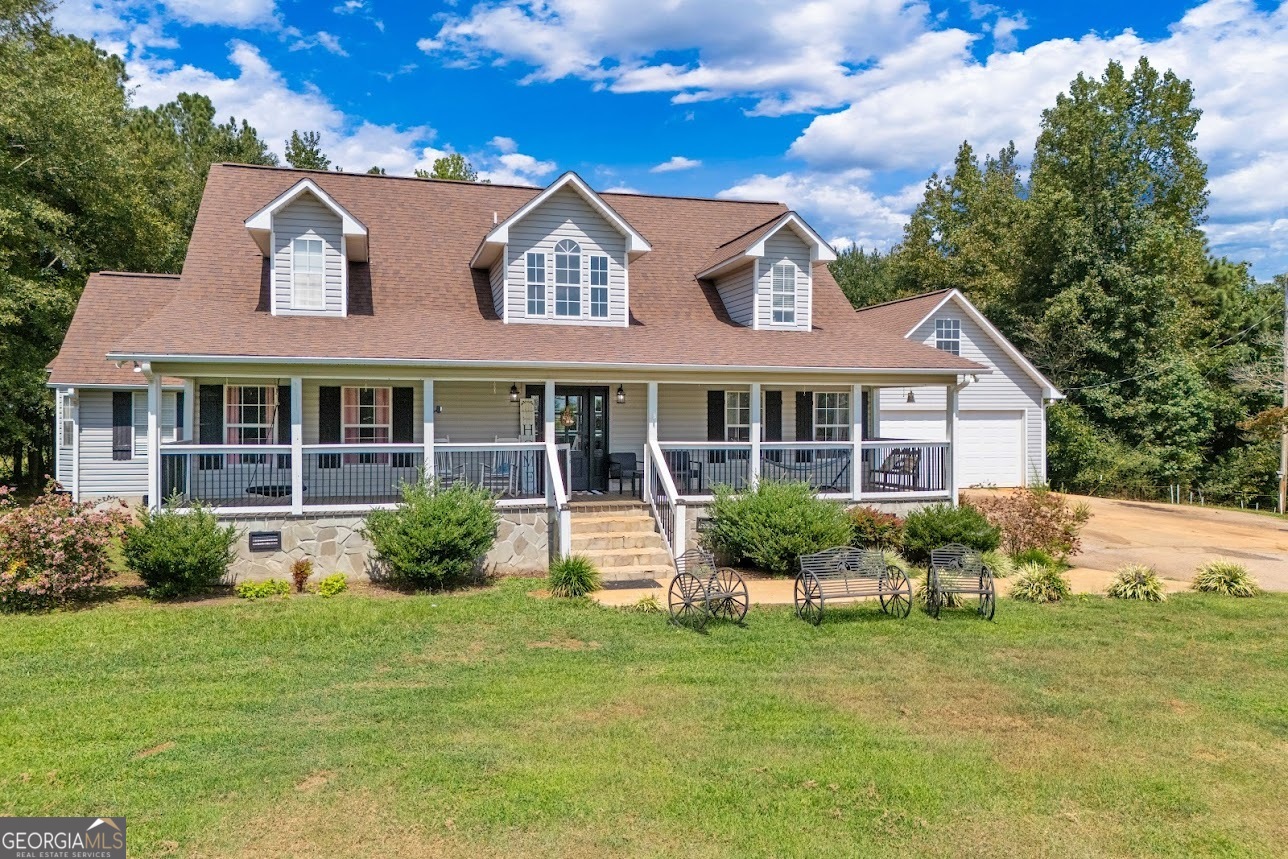 This home is the very essence of beautiful country living wrapped up with a pretty bow and ready for its new owner. You need to see this in person because you will fall in love. From the seclusion of the long driveway to the tree-lined property, you feel like you are in a world of your own. As you enter into the home, you will be invited into the dining room/living room combo, complete with a gas-burning fireplace. This area opens up into the kitchen with breakfast area. The kitchen has an abundance of cabinet space, along with the perfect amount of countertop space to put together all those home-cooked meals. Off of the kitchen is a large office with a sliding barn door and great natural sunlight. The rest of the main floor offers the primary bedroom, with a beautiful walk-in tile shower, separate soaking tub, double vanity, and a large walk-in closet, along with a secondary bedroom, mudroom/laundry room, and a large back porch. The porch opens up to a flat, level back yard that features the in-ground saltwater pool, perfect for all those long summer days! Upstairs holds two well-appointed bedrooms with wonderful closet space, a full bathroom, plus a second living area that boasts vaulted ceilings. This home has space for everyone in the family! All of this sits beautifully on six acres; a small portion is already fenced for those wanting a place for animals. The property also holds a 40x40 workshop complete with power and water! Do not wait, book your appointment today for a private showing.