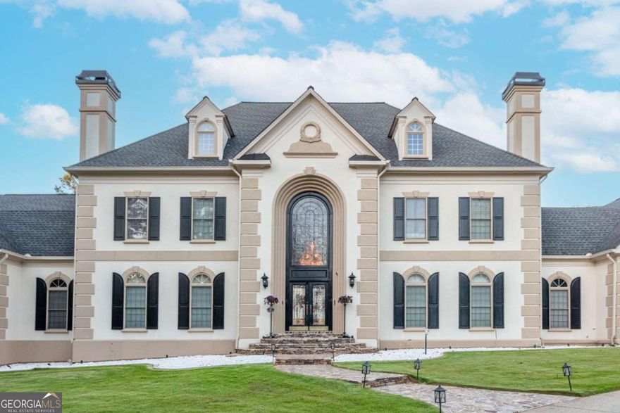 *Major Price Reduction* Take Advantage of Market Conditions! This is a rare opportunity to secure instant equity in one of Marietta's premier estates. The home has been freshly cleaned out and is ready for your vision.  Act fast, schedule your private showing today and bring your best offer before it's gone!    Come experience luxury living in this meticulously maintained Marietta estate in the prestigious Wynthrop Manor community! Nestled on 3.95 private acres, this 13,411 sq. ft. home boasts 7 bedrooms, 6 full baths, and 2 half baths across 3 finished levels. Thoughtfully designed with an elevator, a 6-car garage, and dual laundry rooms on the main and second level, this home offers unparalleled convenience. The main level features 2 bedrooms, 2 full baths, and 1 half bath, along with an extravagant office, elegant dining room, and custom large closets. The second level includes 3 spacious bedrooms and 3 full baths, while the finished basement offers 2 bedrooms, 1 full bath, and 1 half bath, plus a game room, gym, interior koi pond, and hot tub. Outdoors, enjoy the in-ground pool, putting green, and beautifully landscaped yard with a forestry feel. Walking distance to Kennesaw Mountain Park and close to top-rated schools, shopping, and dining. This estate is an absolute must-see!
