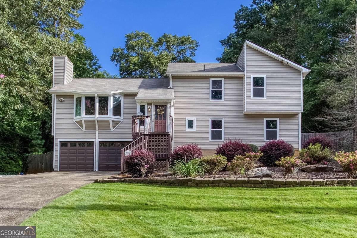 New Roof, New HVAC, New Water Heater, New Windows, new floors upstairs. In 2021 home had new siding and new insulation wrap installed. All of the major stuff has been done. All it needs is a little paint. The kitchen is ready for your culinary adventures with all appliances in place. The home's split-level layout offers versatile living areas, including an unfinished space in the basement that can be customized to suit your needs, whether it's for a recreation room, office, or extra storage.This home offers comfortable and functional living in a highly desirable area. The spacious landscaped lot has a fenced backyard and irrigation in the entire yard. Located in the Cobb school district. Seller offering a $2000 credit for paint.