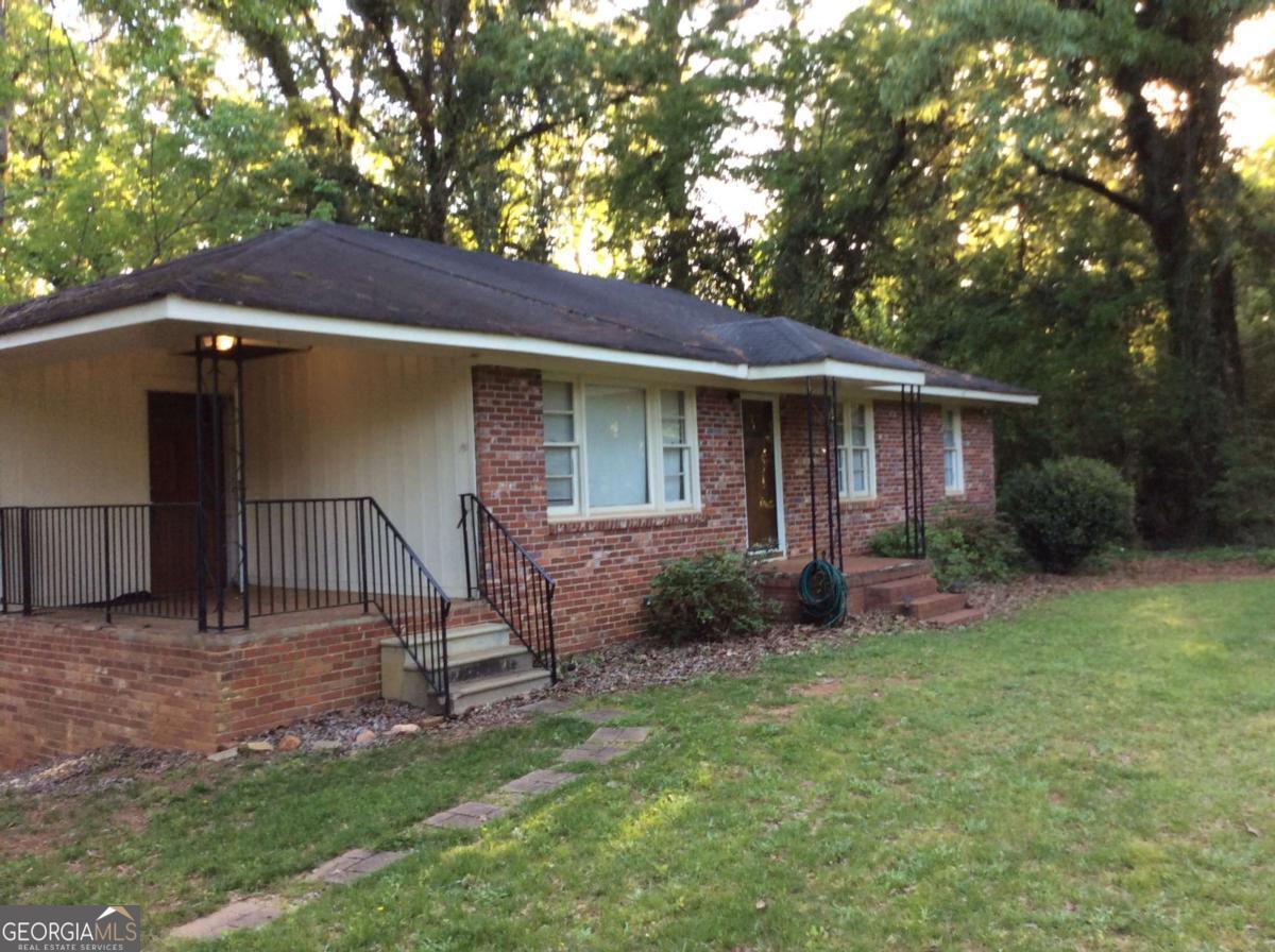 GAMLS lockbox on front door, agent must be at showings, application on website. Cozy cottage nestled on the back of adeep lot. Den, with a fireplace, family room, large windows to watch the flowers in the front yard. applicants must prove 3X monthly rent in income, NO evictions, judgements, liens or dispossessions in the last years, Good residential and employment histories, Good payable credit. No pets and NO smoking