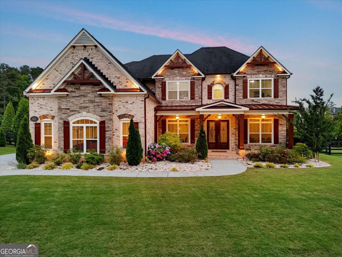 Stunning 4-Sided Brick Oasis - First Time on the Market! Welcome to this beautifully maintained and meticulously landscaped 5-bedroom, 4-bathroom home, offered for the first time ever. From the moment you arrive, the curb appeal is undeniable, and the charm only grows once you step inside. The oversized primary suite is a true retreat, featuring a spacious en-suite bath with a soaking tub, separate shower, and an expansive walk-in closet. The open-concept main level boasts a large living room with a cozy fireplace and a dramatic wall of windows that flood the space with natural light. Perfect for entertaining, the chef's kitchen is a dream-equipped with double ovens, a large center island, island microwave, and floor-to-ceiling cabinetry, all overlooking the living space for easy connection with family and guests. Step outside to a fully fenced, level backyard complete with a gorgeous covered patio-ideal for relaxing or hosting in any season. Plenty of backyard space to add a pool if you desire that private plunge! Located near top-rated schools, popular parks, fantastic restaurants, and great shopping. Just 2 miles from downtown Alpharetta and downtown Crabapple and only 10 minutes to Avalon. This home offers the perfect blend of comfort, convenience, and luxury. Actual new construction completion on this house was July of 2018. Come make this your forever home-you won't want to leave!