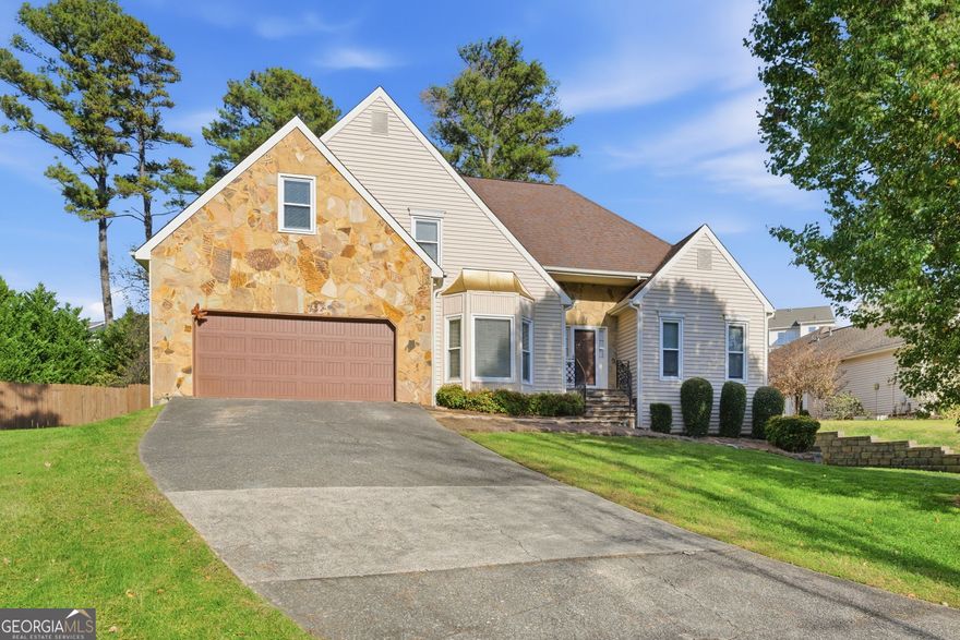 Welcome Home! This stunning 4-bedroom, 2.5-bathroom residence is located just 2.3 miles from Downtown Woodstock, offering the perfect blend of convenience and comfort. Nestled in the highly sought-after Ansley Forest community, residents enjoy access to vibrant swim and tennis amenities. Inside, you'll find hardwood floors throughout and a brand-new chef's kitchen featuring modern finishes and thoughtful upgrades. The primary suite includes a beautifully renovated bathroom with a new walk-in shower showcasing gorgeous tile work. Upstairs, three spacious bedrooms and a full bathroom provide an ideal layout for families. The family room boasts vaulted ceilings and a cozy gas fireplace, perfect for relaxing or entertaining. The home also includes a large unfinished basement, offering excellent storage options and the opportunity for future expansion. Step outside to an expansive deck overlooking an oversized, fenced backyard-ideal for gatherings, pets, or play. Homes in this neighborhood are rarely available-only one home has been listed in the past year, and it went under contract on the first day. Don't miss your chance to see this beauty!