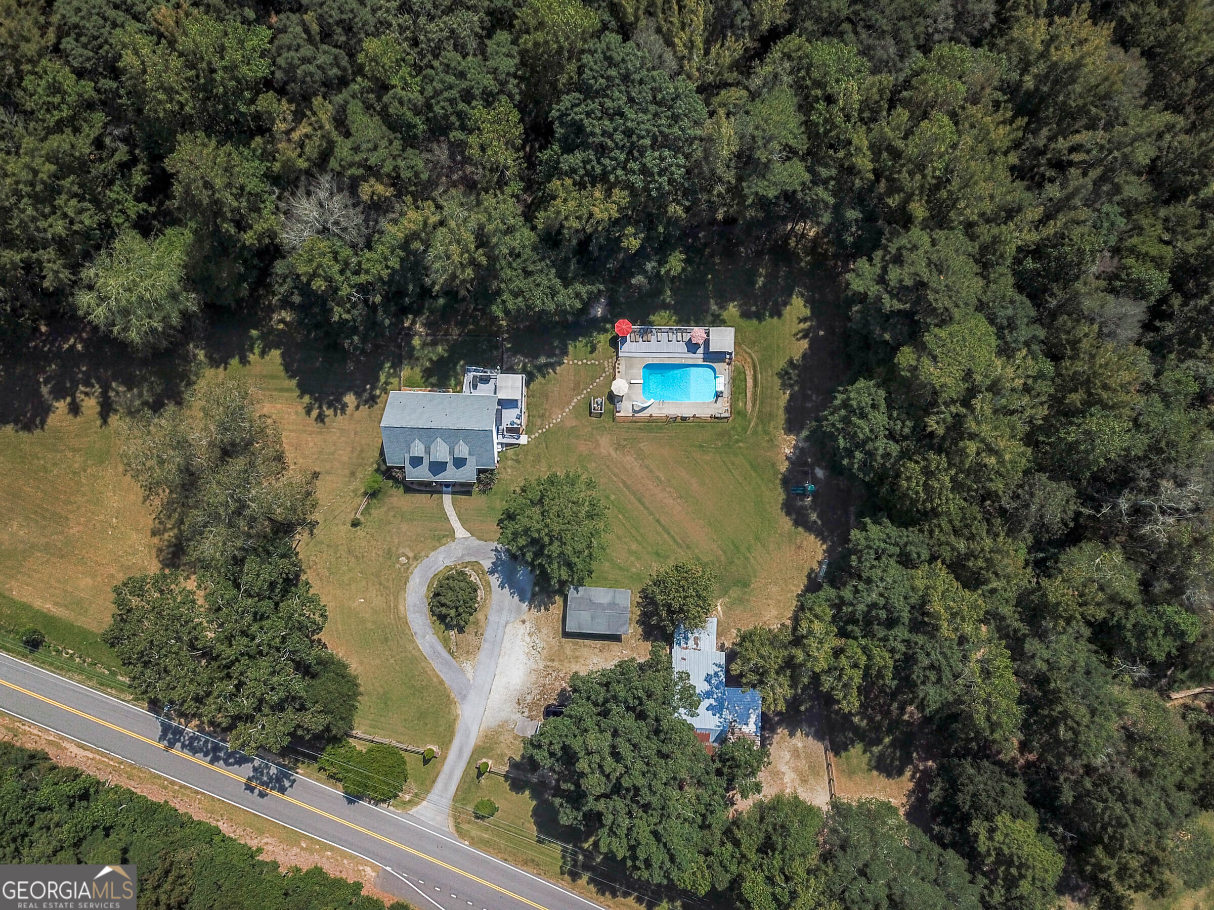 Welcome to country living on almost 10 acres while being conveniently located just 6 minutes to I-85, 24 minutes to Hartsfield Jackson International Airport, and 10 minutes into Peachtree City. You have access to renowned Fayette County Schools: North Fayette Elementary, Flat Rock Middle School, and Sandy Creek High School. This beautiful Cape Cod style home has 4000 sq ft of finished living space that includes a master bedroom, along with one other bedroom and powder room on the main level, 2 bedrooms and a full bathroom upstairs, and a full-finished basement with bedroom, full bathroom, and kitchenette. The basement would make a great in-law suite with it's own entrance. There is an in-ground pool with new pool deck, new liner/filter/pump replaced in 2022, and 100 year old barn with horse stalls and a pasture! The roof is 4 years old, water heater 5 years old, and HVAC is serviced regularly and coil replaces in 2025, plus the home has a newly built front porch and back deck. All the drain lines to the septic field were replaced in 2017. The interior has been freshly painted and newer floors have been installed. The current owner added 2 sliding glass doors from the kitchen/eat-in area to the back deck which wraps around the side of the home. Under the back deck is a covered and fenced patio area. You can access this from the basement as well as from the upper deck and back/side yard. The kitchen has new, leathered, granite counter tops, and painted cabinets. Updated lighting has also been added throughout the home. If you have horses, there's a perfect spot for them in the barn and plenty of space to graze and roam in the pasture. If you don't have horses, you could use the barn for storage. There's a circular driveway and parking area for you and guests, in addition to the covered parking pad. The home has been well taken care of for you so all you need to do is pack your bags and move in!