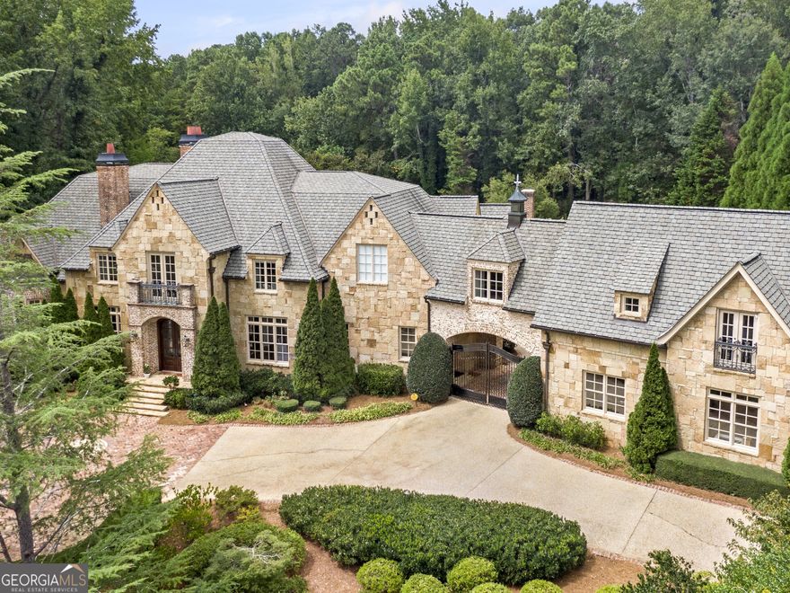This is an extraordinary East Cobb opportunity in Atlanta Country Club, custom-built & fully renovated home by Steve Edison situated on1.3 acres featuring a walk out backyard oasis with salt water pool. This unique property features incredible millwork, timeless elegance & grand living spaces. Heart of the home is a designer chef's' kitchen, complete with dual quartz islands, premium wolf appliances & endless storage. Expansive owner's suite on the main level includes a cozy sitting room with fireplace along with an oversized master bath, and his/hers closets. All secondary bedrooms are extremely spacious ensuites as well as the in-law/guest suite on the 2nd level which has its own private entrance. Just beyond the gated porte-cochere is a rare 6 car garage. The terrace level of this home is exceptional.10' ceilings, gorgeous bar, huge home gym, sauna, large ensuite guest room, and a golf simulator! This is truly an extraordinary home, beautifully updated, meticulously maintained and perfect for entertaining. Located in a top-rated school district, with no HOA in one of the most coveted areas of Atlanta, Welcome Home!