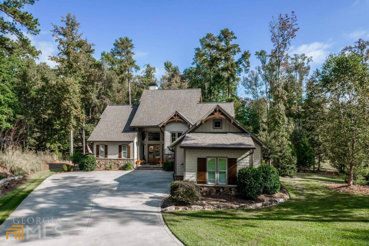 Private homesite with features only found in a custom built home on a wooded home site with fabulous pond views. The home boasts an open floor plan with master suite on main. Gourmet designed kitchen with vaulted ceilings overlooking the great room with fireplace. Vaulted Master Suite with oversized separate shower, & private WC. Huge rear covered porch over looking pond on main level. Terrace level features 3 bedrooms with 3 baths, additional great room, & covered patio. 2 car garage with Golf Cart bay. Current owners have upgraded to include an out door hardscape off the terrace level to include stone, built in grill, and sitting area. Other upgrades include: heavy trim, massive windows through out to bring in the natural light, flooring, lighting, and plumbing to mention a few. A unique and one of a kind exceptionally well maintained home in Harbor Club. A great value on a fabulous home!