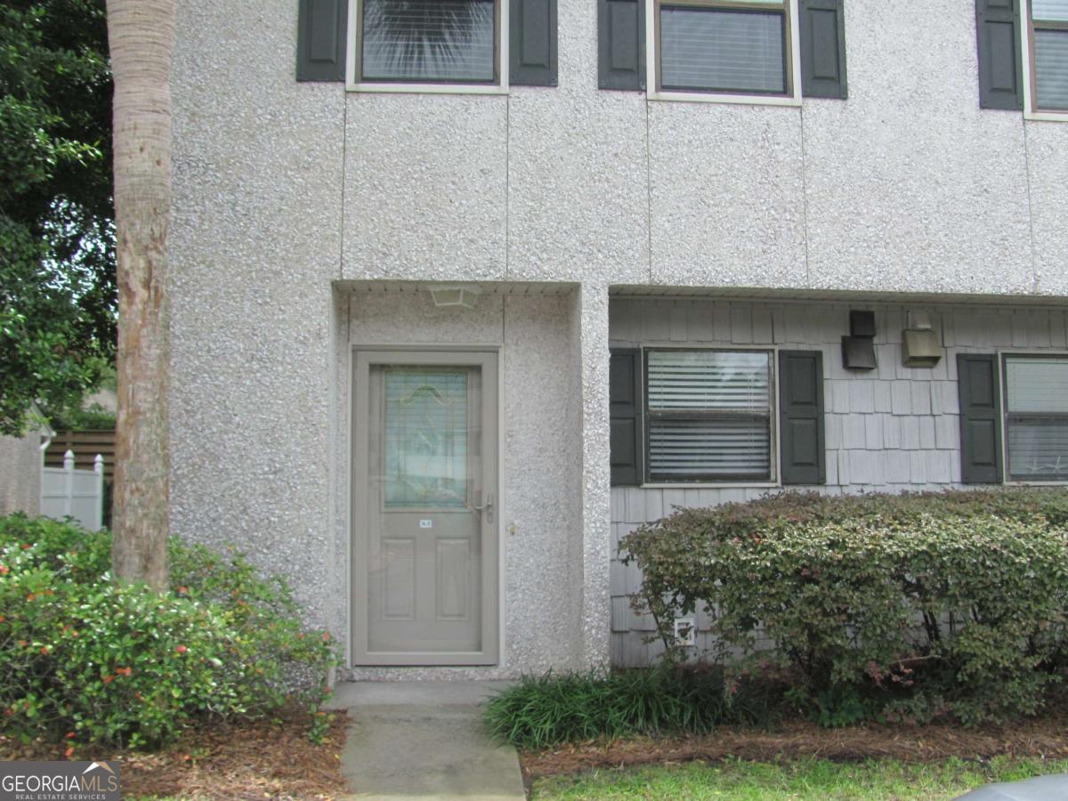 Stress free living in this 2 bedroom 1 and a half bath townhome located within walking distance to the Pier Village and shops, restaurants, the beach and more! The first floor features a spacious living/dining area and there is a half bath just off the foyer. There is also storage space under the stairs. The first floor is completely tiled and there is recently replaced carpet in the two upstairs bedrooms where you will find a full bath. The washer and dryer are located off the hall between the 2 bedrooms. The water heater is only 1 year old. The rear door leads to an attractive and private brick patio which is where you'll find an additional storage room. Townhomes in Courtyard Villas are hard to come by so don't let this one get way!!