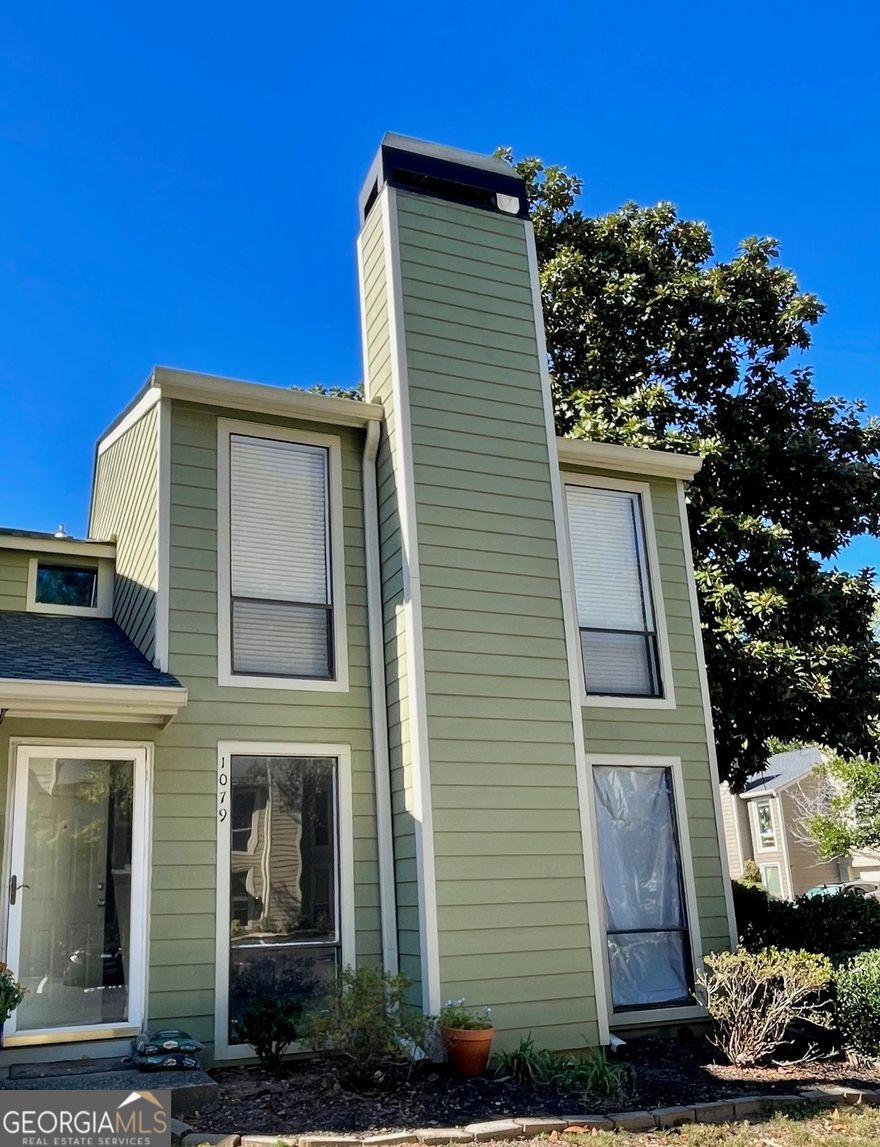 INVESTOR SPECIAL - SOLD "AS IS" WITH RIGHT TO INSPECT.  No Disclosure due to the current owner not ever living in the unit.   End Unit Townhome in a Gated Community  Fantastic opportunity for investors or buyers ready to customize their dream home! This end-unit townhome offers abundant natural light, added privacy with only one shared wall, and a premier location near the Chattahoochee River. A recent pipe leak near the hot water heater caused flooding on the first floor. The remediation team has already completed the hard work - drywall removed several feet up, flooring taken out, and damaged materials professionally removed, including the half bath fixtures, lower kitchen cabinets, and all appliances. The home is now a clean slate, ready for your personal design and finishing touches. You can start fresh or consider reinstalling the existing cabinets and appliances that remain on site. New flooring will be needed throughout the first level, and the upstairs carpet is due for replacement. Upstairs, the primary suite features two closets and a private bath with space to easily convert the single vanity into a double. The secondary bedroom includes a walk-in closet and private bath.  The HOA is at rental capacity and a 3 year wait for leasing.    Enjoy the landscaped yard and relax as you watch the Chattahoochee River flow by. Walk to Ray's on the River for dinner or take advantage of easy access to I-75, I-285, The Battery/Braves Stadium, Chattahoochee River Nature Preserve, Ackers Mill retail and dining, Cumberland Mall, and Costco.   This is a prime location and a perfect project property - the hard part is done; now it's ready for your vision!