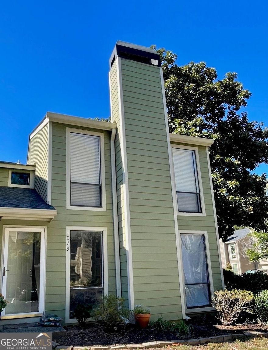 INVESTOR SPECIAL - SOLD "AS IS" WITH RIGHT TO INSPECT.  No Disclosure due to the current owner not ever living in the unit.   End Unit Townhome in a Gated Community  Fantastic opportunity for investors or buyers ready to customize their dream home! This end-unit townhome offers abundant natural light, added privacy with only one shared wall, and a premier location near the Chattahoochee River. A recent pipe leak near the hot water heater caused flooding on the first floor. The remediation team has already completed the hard work - drywall removed several feet up, flooring taken out, and damaged materials professionally removed, including the half bath fixtures, lower kitchen cabinets, and all appliances. The home is now a clean slate, ready for your personal design and finishing touches. You can start fresh or consider reinstalling the existing cabinets and appliances that remain on site. New flooring will be needed throughout the first level, and the upstairs carpet is due for replacement. Upstairs, the primary suite features two closets and a private bath with space to easily convert the single vanity into a double. The secondary bedroom includes a walk-in closet and private bath.  The HOA is at rental capacity and a 3 year wait for leasing.    Enjoy the landscaped yard and relax as you watch the Chattahoochee River flow by. Walk to Ray's on the River for dinner or take advantage of easy access to I-75, I-285, The Battery/Braves Stadium, Chattahoochee River Nature Preserve, Ackers Mill retail and dining, Cumberland Mall, and Costco.   This is a prime location and a perfect project property - the hard part is done; now it's ready for your vision!