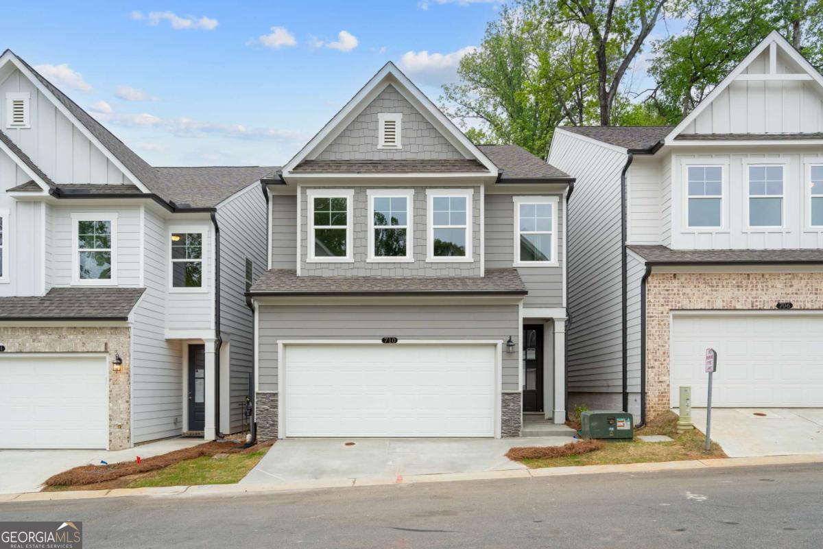 READY NOW!!! Welcome to The Marion B lot 66, a stunning 3-bedroom, 2.5-bath residence in the sought-after GATED Village at Shallowford just steps from pool and clubhouse. This move-in-ready home spans 2,008 sqft, combining elegance with practicality. The open layout invites you into a bright foyer leading to a gourmet kitchen with a large island, 42" cabinets, gleaming Quartz countertops, and top-of-the-line stainless-steel appliances. Relax in the cozy living room, complete with a charming shiplap fireplace and 9 FT ceilings throughout the main level, or entertain guests in the adjoining dining room with easy access to the private patio. Retreat to the oversized primary suite, offering a luxurious extended tile shower and a walk-in closet, providing a peaceful escape from the secondary bedrooms. Enjoy the open railing staircase that adds a feeling of light and spaciousness and oak treads on the stairs enhance the sophisticated ambiance. Set within the ONLY gated community with a pool and clubhouse in Kennesaw, enjoy quality amenities and proximity to excellent schools. With its charming exteriors and open floor plans, this home is a true gem. Self-guided tours available!