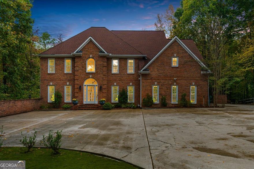 Your Private Roswell Retreat Awaits! Discover the perfect blend of luxury, privacy, and convenience in this stunning 5-bedroom, 4.5-bath custom home, beautifully renovated from top to bottom and nestled on over 3 acres in the heart of Roswell. Tucked away on a private paved drive, this home feels like your own secluded oasis-yet you're only minutes from downtown Roswell's shops, restaurants, and entertainment. Step into the impressive two-story foyer, where natural light and elegant finishes immediately set the tone for this exceptional property. The main floor offers a private office with floor-to-ceiling built-in bookshelves, a formal dining room, and a beautiful sitting room perfect for entertaining or quiet conversation. The soaring two-story great room, anchored by a cozy fireplace, opens to a bright and inviting kitchen. Featuring a custom island, stainless steel appliances, and a sun-filled breakfast nook, this kitchen is truly the heart of the home. From here, enjoy easy access to the expansive back deck overlooking the private fenced yard and serene wooded acreage beyond-ideal for entertaining or relaxing in nature. Upstairs, the primary suite is a luxurious escape. The renovated primary bath offers a soaking tub, dual vanities, and a stunning custom shower. The walk-in closet is simply spectacular! It is an absolutely breathtaking space that's as functional as it is beautiful.Two additional bedrooms and two fully renovated baths complete the upper level, providing comfort and sophistication for family or guests. The finished terrace level is designed for versatility and entertainment, featuring a large recreation room, gym, theater, or guest suite, with an additional full bath and office space that could double as another bedroom. Step outside to the covered patio with waterproof underdecking that overlooks the heated gunite pool (resurfaced in 2022), surrounded by a gorgeous flagstone patio that creates the perfect resort-style setting. This home has been meticulously cared for and thoughtfully upgraded, including a whole-house generator, upgraded well pump, two whole-house dehumidifiers, new gutters, new HVAC, Moen whole-home water monitoring system, and new basement flooring. With no HOA, unmatched privacy, and a location that offers the best of both worlds, this property is truly one of a kind. This rare retreat truly has it all-luxury, privacy, and location. Welcome home.