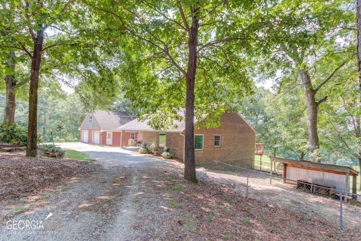 Fabulous 19.61 Acre Horse farm with 4-sided brick ranch home with daylight basement. Complete with 7 Stall horse barn, pasture, arena and round pen. Home features one bedroom and bath on main and three bedrooms and two full baths in daylight basement. Separate spacious dining and family rooms. Main level has Pergo laminate flooring throughout. Office on mid-level. Large combined laundry room and pantry off country kitchen. Basement level has new luxury vinyl flooring. built-in shelving and wood burning stove that heats the entire home. New 36COX11CO wood deck overlooks the 3 acre fenced front pasture. Covered front porch. Beautiful landscape and gardens. Detached 30COX24CO concrete block shop, 2 car garage, 17COX23CO unfinished bonus room. 4-sided brick masonry constructed home with 13 inch walls is extremely thermal efficient and has newer Andersen Windows. Majority of property is fenced and gated, mostly rolling topography and is all usable. Behind the barn is an additional 5+ acres that is cross fenced. New Equine no climb fence installed in horse pastures. 7 stall horse barn - 30 ft X48 ftbarn with side shelters for hay and equipment storage. Metal Roof. Each stall is 10COx12CO. Barn includes half bath, tack room with saddle racks.10CO center aisle. Rubber mats throughout. Fluorescent lights and ceiling fans. 150 ftX55ft riding arena, 65 ft round pen. Electric and water at barn. Income potential as a boarding barn is $500/mth per horse. Total Electric home. No HOA.