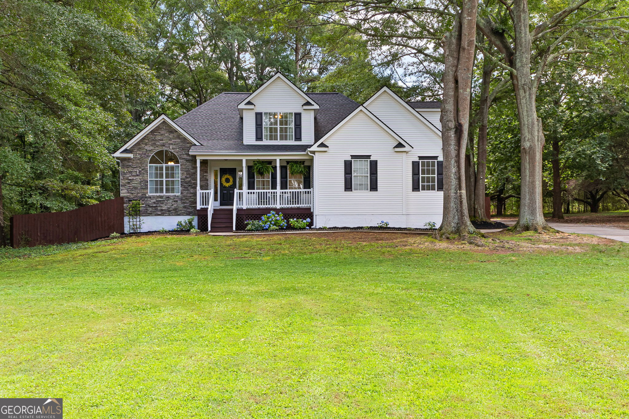 Stunning, 6-Bedroom Home with Fully Finished Basement In-Law Suite in Northgate School District - No HOA! Perfect for multi-generational living or extra income potential. This beautifully remodeled 3-story, 6-bedroom, 3.5-bath, home offers over 3,000 sq. ft. of spacious living in the highly desirable Northgate School District of Coweta County. Located on a .94 acre, cul-de-sac lot, this property has so much to offer! The main level showcases hardwood floors and a multi-room audio system, a spacious primary suite with vaulted ceilings, judges paneling, and a luxuriously large, custom tile shower with seamless glass, separate vanities, and a custom shelving walk-in closet. The laundry room is also conveniently located on the main level just off the kitchen and garage. The 2- car garage located off the kitchen, has 12 ft ceilings and copious amounts of shelving for storage. The open concept kitchen is truly great for entertaining as it features a large island featuring dual mini-fridges and a separate ice machine, granite countertops, stainless steel appliances, tile backsplash, dual pantries, coffee bar, and a sunny eat-in breakfast area. The living room features a vaulted ceiling, a stacked stone gas fireplace, with a shiplap accent wall for mounting your t.v. In addition, there is also a separate formal dining room. On the upper level you will find 3 bedrooms, a full tiled bathroom, and walk-in attic with plenty of room for seasonal storage. The full finished basement with separate exterior entrance, is ideal for multi-generational living or potential rental income. The basement includes 2 additional bedrooms, a full bath with tiled flooring and a shower/tub combo. The kitchen is tiled with granite counter-tops, updated cabinets, stove, built-in microwave, refrigerator, coffee bar/pantry, hookups for a stackable washer/dryer, living room, and bonus space perfect for a home theater, home gym, or extra storage. Enjoy outdoor living on the new 16-ft deck overlooking the fully fenced, private backyard complete with a fire pit. There's also additional gravel parking behind the home, ideal for RV or boat parking, and no HOA. Brand new carpet as as of June 2025, 16 ft. deck replaced January 2025, roof replaced 2023, and septic serviced June 2024. This home truly has it all-space, style, functionality, and a prime location! Located conveniently between Newnan, Peachtree City, and Sharpsburg. Easy access to I-85 and shopping.