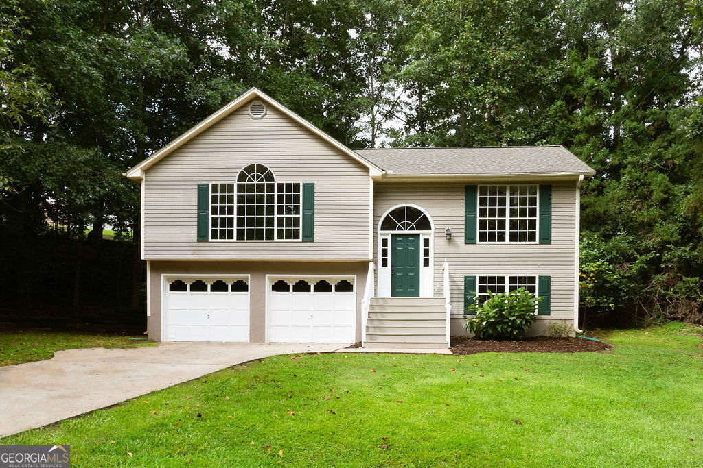 Spacious 3BR/2BA COMPLETELY remodeled in Waterfront Community. This home has an open floor plan with a nice vaulted ceiling in living room with hardwood flooring throughout. Living room has a large open window providing great natural lighting. Master in located on main with a spacious walk-in-closet with en-suite bath with garden tub with separate shower. 2 bedrooms are located downstairs with a full bath. Covered deck in rear great for relaxing with extra storage shed, spacious 2 car garage. Home is located a few miles from Gainesville Marina for great enjoyment of Lake Lanier.