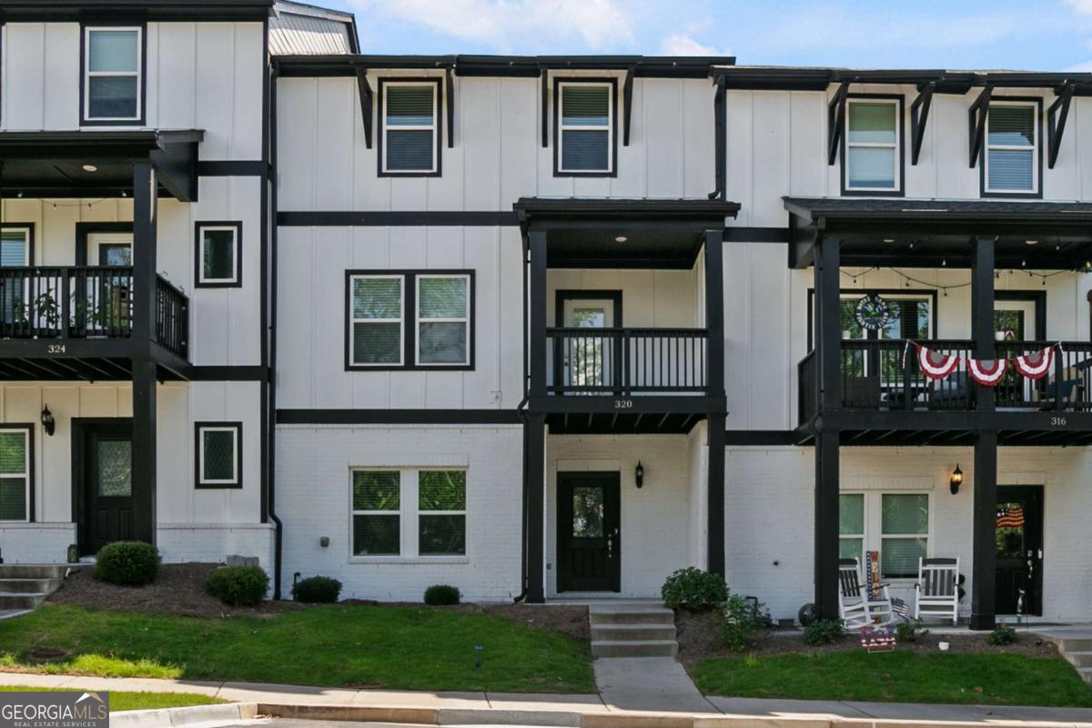Gorgeous townhome in the perfect location! Close to shopping, dining, walking trails, downtown Woodstock and 575. This townhome features 3 stories, entering into the lower level featuring a bedroom, full bathroom and 2 car garage with opener. Heading upstairs to the main level, you'll find an open, spacious floorplan with luxury vinyl plank flooring throughout. The kitchen features a large island, light grey cabinetry, beautiful backsplash, large pantry and stainless appliances including double ovens, microwave, gas cooktop and dishwasher. The kitchen is flanked by the great room and dining room. The main level also features a half bath and closet. There is a covered front deck off the dining area. Heading upstairs, you'll find three bedrooms, including the owner's suite with large closet. The owner's bath has an oversized, tiled shower and double vanities. There are two secondary bedrooms and a full bath with double vanity and tub/shower. The laundry room is also on the upper level. Window treatments throughout home and move-in ready. Enjoy easy living in this energy efficient townhome and relax by the community pool.