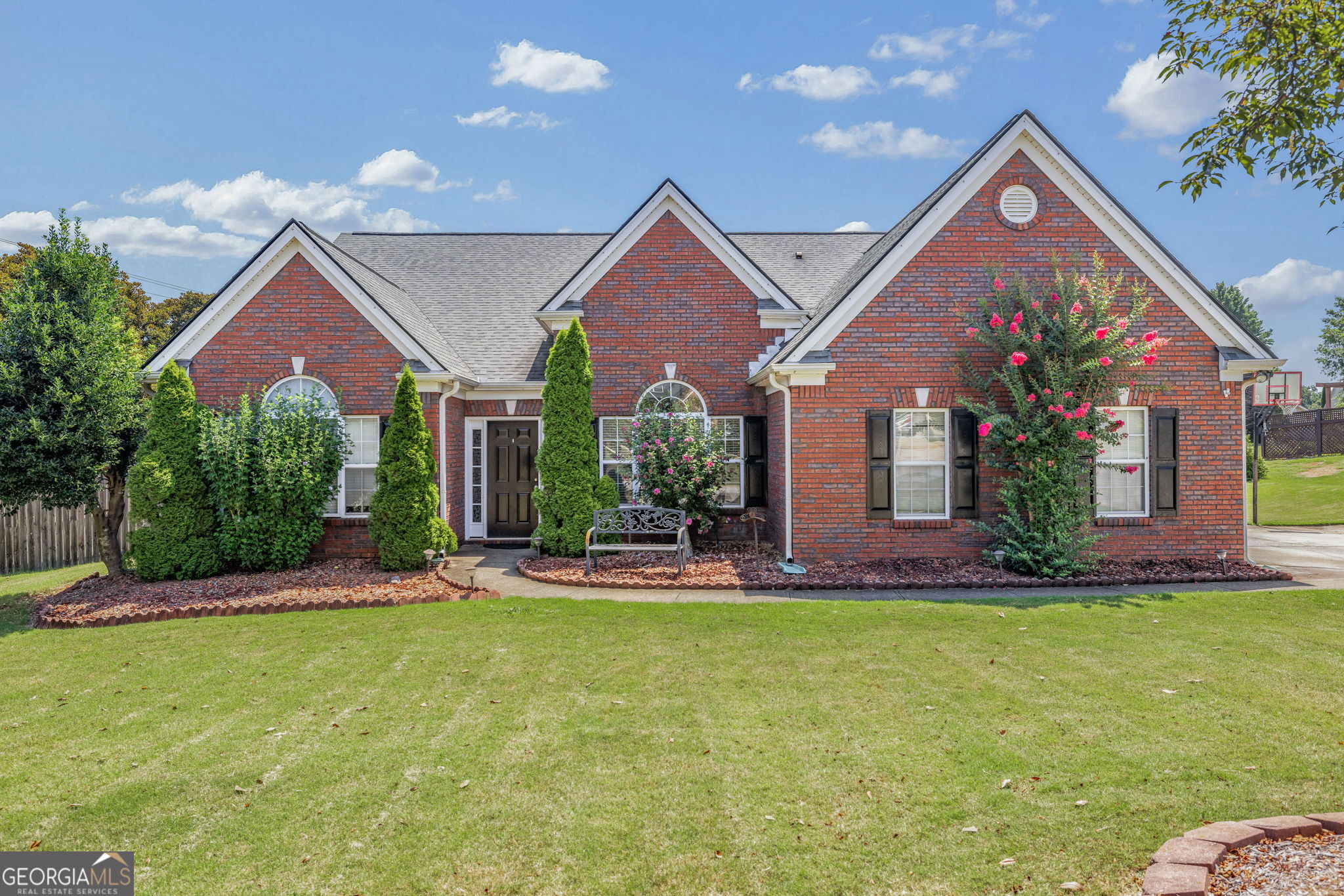 Charming Ranch on Nearly an Acre - Walk to West Jackson Schools! Don't miss this fantastic 4-bedroom ranch home nestled on just under an acre in a prime location! The spacious open floorplan features a large kitchen with granite countertops, white cabinetry, a tiled backsplash, and seamless flow into the inviting family room-perfect for everyday living and entertaining. Step outside to a fully privacy-fenced backyard that's ready for relaxing and homesteading, complete with a covered back porch, hot tub (included with the sale), chicken coop, garden area, and outdoor storage building. Major system updates include a new HVAC system (replaced 2 years ago) and septic tank pumped less than 2 years ago, offering peace of mind and added value. Located within walking distance to West Jackson schools, this home is being sold As-Is and is in good condition-the deck does need some work.