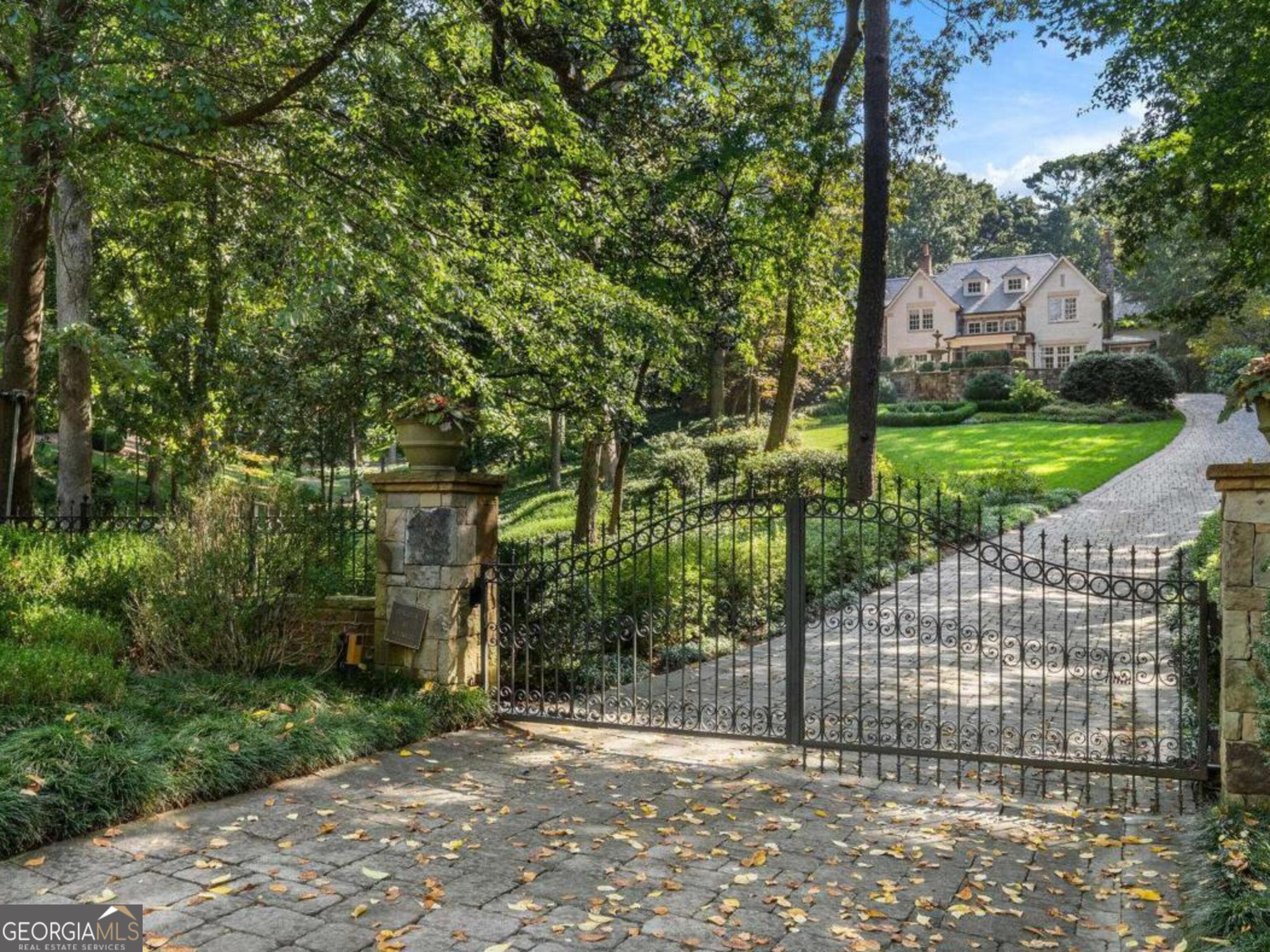 Spectacular private gated estate on 1.3 fenced acres off of Mount Paran in the highly desired neighborhood that is a series of cul de sac streets in Buckhead. Perfect for walking with no cut through traffic. Separate monitored security for the neighborhood.  Exceptional builder, Tony Reaves, Intown Builders and Harrison Design architects created this masterpiece of brick, stone and a slate roof. Perched up on the hill and overlooking the combined parcels.  View and walk out to the pool from the living, family room and kitchen.  Outdoor entertaining spaces with covered outdoor kitchen and fireplace. The redone kitchen is open to the family room with brick barrel ceiling and fireplace and all opens to the pool.  Ceilings throughout are 10 - 12 feet and a two story foyer. This property is fully loaded with Control 4 technology, elevator, whole house generator, Control 4 lighting, security and music throughout.  The chef's kitchen has double Sub Zero refrigeration, drink drawers, icemaker and Wolf appliances, Calacatta gold marble countertops and custom Karpaty cabinetry. Two primary bedroom suites, one on the main and one upstairs. There are four more on-suite bedrooms upstairs and a TV or game room.  Fully finished terrace level with bar, home theater, game room, gym, billiards and ping pong. Oversized garages and porte-cochere with loads of extra parking at the main house and on the side lot.  Enjoy a movie in the theater that seats 10+, spectacular redone double private pool, spa and waterslide. Major renovations and quality upgrades throughout. If you have been looking for the perfect private home in superb quality and condition, transitional and fresh, private and move in ready, this is it! The one acre lot next door can be purchased separately if desired. Located in the highly desirable 30327 and close to everything in Buckhead, Sandy Springs and Chastain Park.