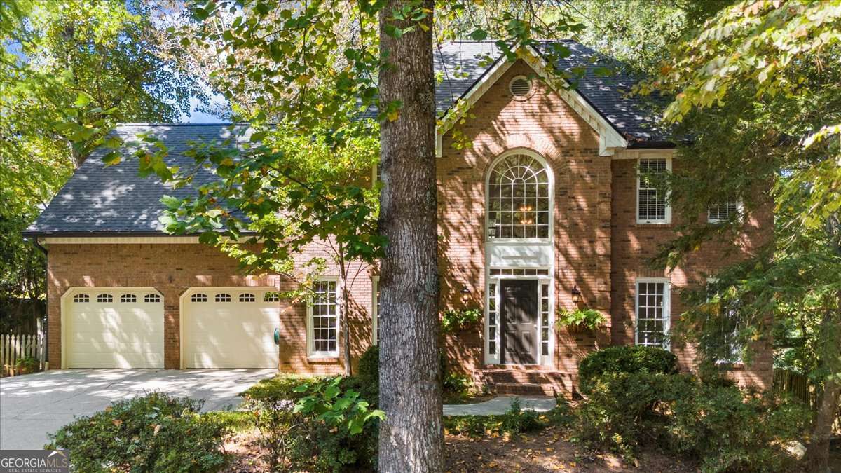 Some houses just feel right the moment you walk in. 1799 McLain Road is one of them. Classic brick on the outside, warm and inviting on the inside-and lovingly cared for by the same owner since 1998. Nestled in Brookstone, one of Acworth's most beloved neighborhoods, this home comes with more than walls and windows, it comes with a history of being well-loved. Here, weekends are spent poolside, afternoons are for tennis matches or golf rounds, and evenings wind down on your own back deck, surrounded by trees. Inside, the two-story foyer sets the tone: light-filled, gracious, and just a little grand. To the left, a dining room that's seen holiday meals and birthday candles; to the right, a flex space ready to be a home office, reading nook, or music room. Straight ahead, the family room pulls you in with its fireplace, wall of windows, and a door out to the deck. The kitchen is the heartbeat of the home. With white cabinets, double ovens, and a vaulted breakfast nook where sunlight pours in through skylights. All the bedrooms live upstairs, keeping the main floor wide open for entertaining. The primary suite is your retreat; tray ceiling, spa bath with soaking tub, dual vanities, and a treetop view that makes mornings better. Three more bedrooms with walk-in closets and a double vanity bath mean there's room for everyone. And then there's the basement! An entire level of possibilities. Movie nights, a home gym, space to tinker, create, or play. It's ready for whatever story you want to write next. Out back, the deck stretches wide, overlooking a private wooded yard. This isn't just a house. It's a home made for gathering, growing, and living well in Brookstone.