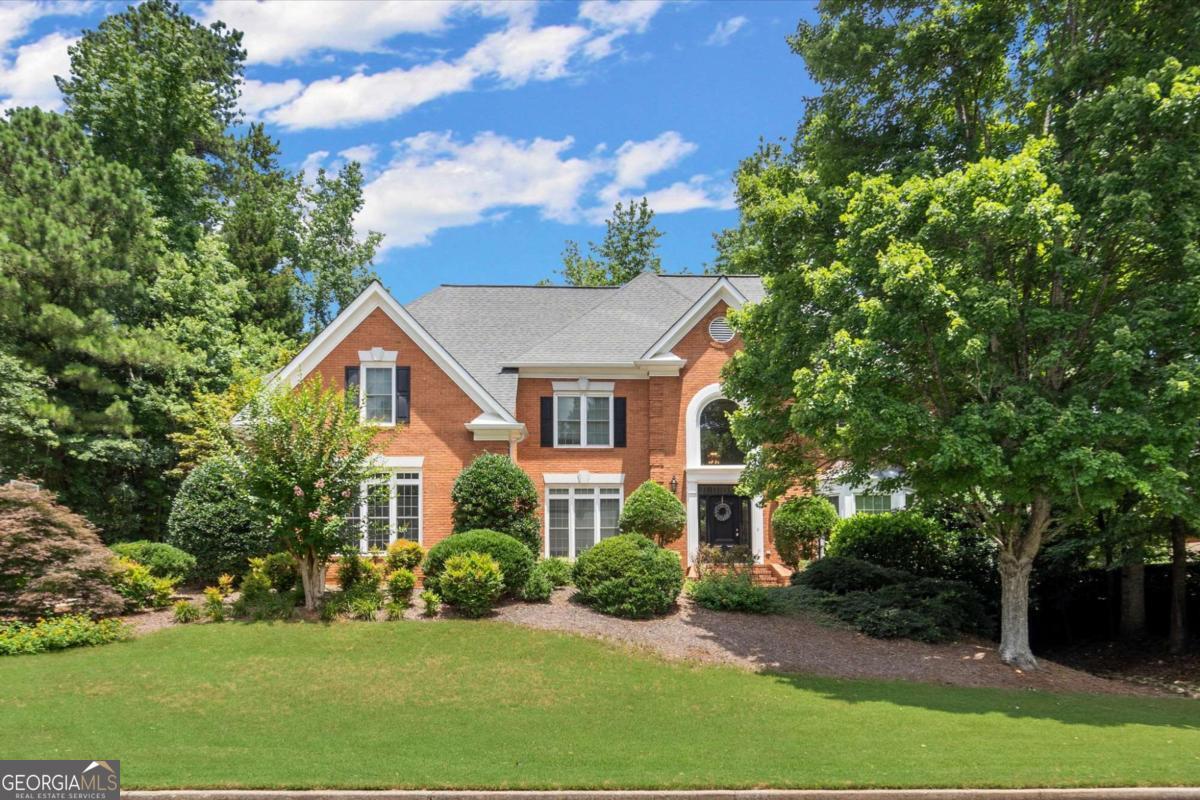 Welcome to Your Hidden Gem in Alpharetta/Johns Creek! Nestled in one of the most sought-after areas, this timeless 4-sided brick traditional home is ready for your personal touch. The main level features gleaming hardwood floors, a full bedroom and bath, formal living and dining rooms, and a spacious family room with elegant built-in bookcases. The light-filled kitchen opens to a cozy breakfast room and a sunroom-ideal for morning coffee or afternoon relaxing. Upstairs, the oversized primary suite boasts a private bath, while three additional bedrooms offer generous space and ample storage. The fully finished terrace level is an entertainer's dream, complete with rich wood finishes, a full bar, theater area, bonus room (perfect as a guest bedroom), full bath, and a game room. Step outside to enjoy the large deck, fire pit, and a private backyard perfect for gardening, play, or outdoor entertaining. All of this comes with resort-style amenities: pool, tennis courts, playground, lake, and more! Close to top-rated schools, parks, and shopping-this is your opportunity to create the home of your dreams in an unbeatable location. Don't wait-make this one yours today!