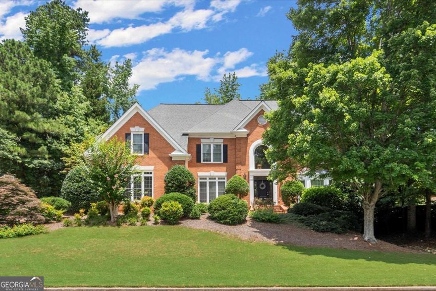 Welcome to Your Hidden Gem in Alpharetta/Johns Creek!    Nestled in one of the most sought-after areas, this timeless 4-sided brick traditional home is ready for your personal touch. The main level features gleaming hardwood floors, a full bedroom and bath, formal living and dining rooms, and a spacious family room with elegant built-in bookcases. The light-filled kitchen opens to a cozy breakfast room and a sunroom-ideal for morning coffee or afternoon relaxing.    Upstairs, the oversized primary suite boasts a private bath, while three additional bedrooms offer generous space and ample storage. The fully finished terrace level is an entertainer's dream, complete with rich wood finishes, a full bar, theater area, bonus room (perfect as a guest bedroom), full bath, and a game room.    Step outside to enjoy the large deck, fire pit, and a private backyard perfect for gardening, play, or outdoor entertaining. All of this comes with resort-style amenities: pool, tennis courts, playground, lake, and more!    Close to top-rated schools, parks, and shopping-this is your opportunity to create the home of your dreams in an unbeatable location. Don't wait-make this one yours today!