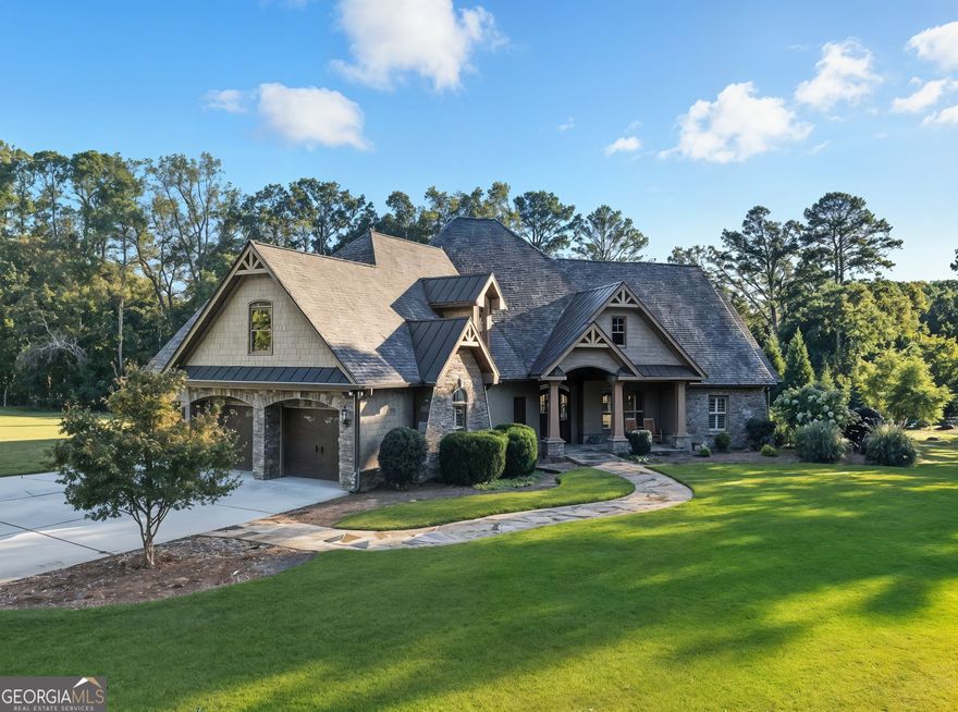 Welcome to a one-of-a-kind property offering flexibility, privacy, and luxury on two parcels totaling over 6 acres in sought-after Canton. The main residence features 4 bedrooms and 3.5 baths with modern farmhouse style throughout. Enjoy an open-concept living space with a gourmet kitchen boasting an oversized island, granite countertops, stainless steel appliances, and walk-in pantry-all opening to a fireside family room with coffered ceilings. The main-level primary suite includes a spa-inspired bath with soaking tub, separate shower, and dual vanities. Step outside to a stunning covered porch with a rock fireplace, cathedral wood ceiling, and views of the in-ground saltwater pool with rock waterfall-perfect for relaxing or entertaining year-round. The second parcel offers unmatched versatility and investment potential. It features a 60x100 building with a 10-car garage, a 1-bedroom, 2.5-bath mother-in-law suite, a man cave, 24x50 RV storage, and an additional 6-car garage. Ideal for car enthusiasts, hobbyists, multi-generational living, or those seeking the option to rent or sell the second lot separately. Enjoy peaceful acreage with convenient access to Milton, Woodstock, and Downtown Canton. This extraordinary property delivers luxury living, functionality, and income potential-all in one.