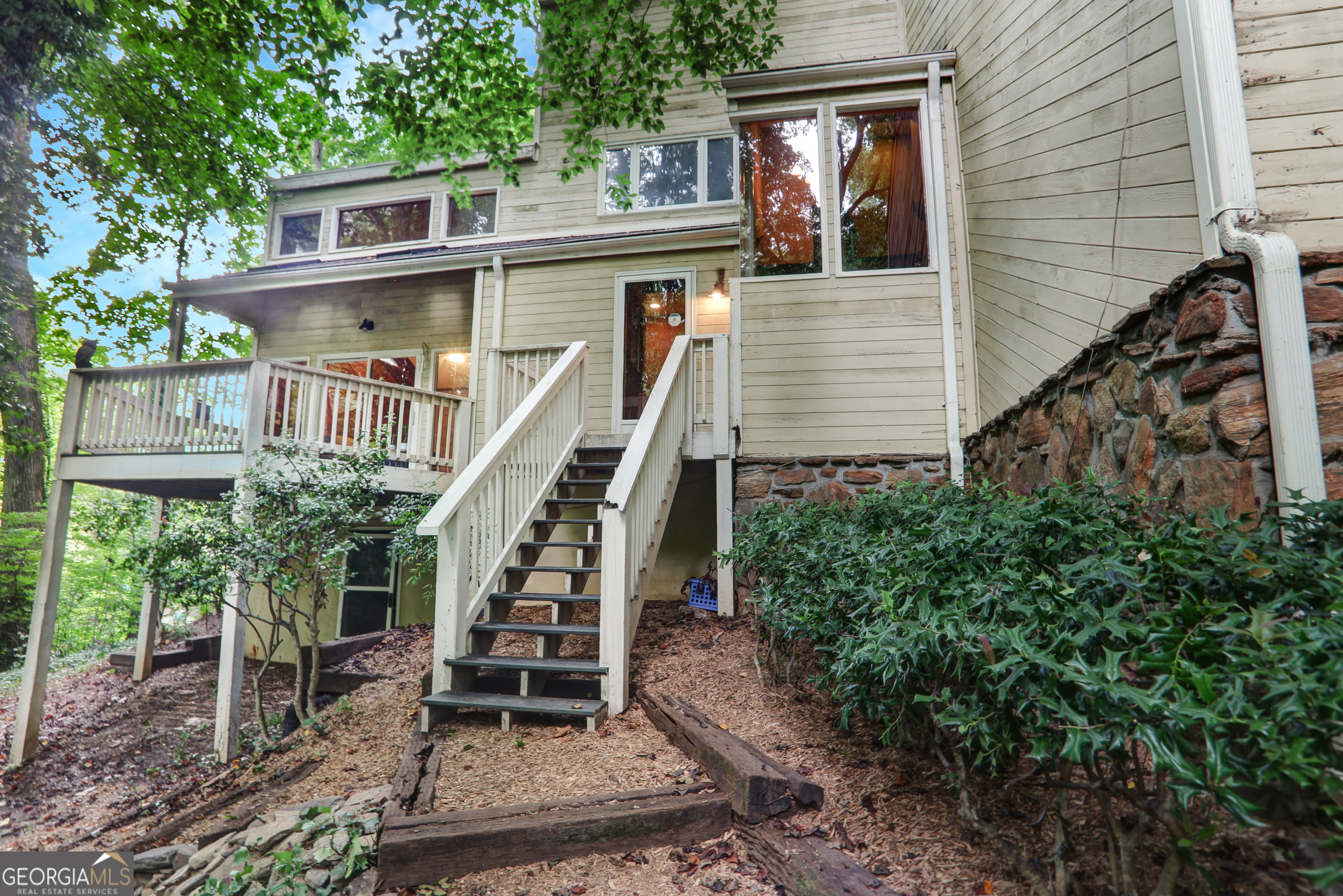 Tucked away on a quiet cul-de-sac in one of Atlanta's most desirable neighborhoods, this unique property offers a rare opportunity to create your dream home in a truly special setting. Overlooking a serene creek and nestled among mature trees, you'll feel like you're living in a treehouse in the heart of the city. This home offers 4 bedrooms and 2 full baths/2 half baths with great bones and a layout full of potential. Whether you're dreaming of a full renovation or a creative refresh, this is your chance to craft something spectacular in a picture-perfect location. Nature lovers and bird watchers will appreciate the peaceful sights and sounds of deer and wildlife. Bring your contractor and your vision - this property is ready to be transformed into a modern masterpiece or a cozy, wooded sanctuary. Located just minutes from Town Brookhaven, top-tier schools, shopping, dining, parks, and major highways, 1255 Old Woodbine Rd offers the best of both worlds: the tranquility of nature with the convenience of city living.