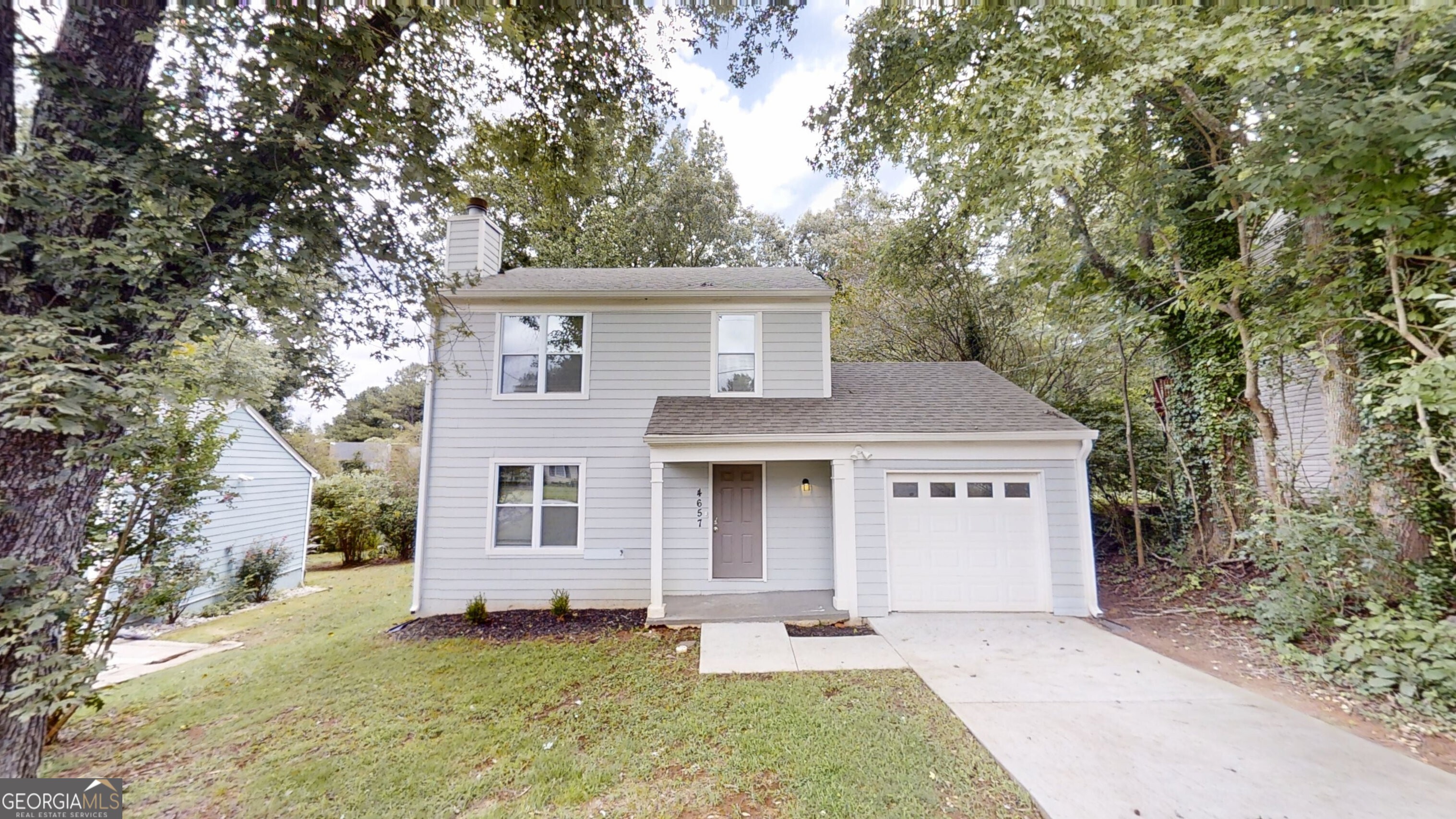Welcome to this beautifully updated home in the desirable Laurel Oaks community! Freshly painted throughout, this charming residence offers a spacious and inviting layout with luxury tile flooring on the main level and plush carpet upstairs for added comfort. The cozy family room features a warm fireplace flanked by custom built-in shelving, creating the perfect space for relaxing or entertaining. The modern kitchen boasts white cabinetry, granite countertops, and stainless steel appliances, ideal for any home chef. Upstairs, you'll find three comfortable bedrooms, including a generous primary suite. Step outside to enjoy a large private backyard and rear deck perfect for entertaining guests or enjoying quiet evenings outdoors. Don't miss your chance to own this beautiful home in Laurel Oaks schedule your showing today!