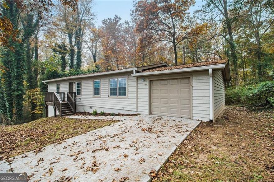 Here's the truth nobody wants to tell you: While you're waiting for the "perfect" home to magically appear at the "perfect" price, someone else just bought this one. At $215,000, this property solves the exact problem keeping you up at night, finding something genuinely affordable that doesn't require a contractor on speed dial or a two-hour commute to anywhere that matters. What you're looking at here is 1,224 square feet of genuinely practical living space, where someone clearly understood that not every home needs to shout to make its point. The taupe cedar siding blends naturally with the wooded surroundings, while that elevated deck out back promises morning coffee sessions accompanied by nothing but birdsong and rustling leaves. Step inside and you'll find what sensible really looks like. Wood-look tile flooring flows throughout, giving you the warmth of hardwood with the durability that handles real life without complaint. The living space opens directly to the dining area and kitchen, creating that natural circulation where conversations drift from room to room without missing a beat. Those cherry-toned cabinets? They're paired with gleaming granite countertops and stainless appliances including a gas range for anyone who takes cooking seriously. Over-the-range microwave saves counter space, dishwasher means less time at the sink. The primary bedroom sits privately positioned with its own ensuite bath, while two additional bedrooms share the second full bath, both featuring crisp white fixtures and clean finishes that make mornings feel less like a chore. Fresh paint in calming neutrals creates that blank canvas where your furniture and life fill in the personality. Now step outside. That deck overlooks a backyard sloping gently toward the tree line, where nature provides all the privacy fence you'd ever need. The lot drinks in fallen leaves, creating that quintessential autumn scene that reminds you why people choose Lithonia over cramped intown living. Room for a fire pit, room for dogs to roam, room to actually breathe. Real estate is about location, and The Trace delivers exactly what east DeKalb buyers want. You're less than two miles to Covington Highway's retail corridor with Kroger, Walmart, daily needs handled. Stone Mountain Park sits five minutes north for weekend trail runs or lazy lake days. I-20 is three miles south for the westbound commute, Stonecrest Mall practically next door. Arabia Mountain's hiking trails? Ten minutes. Downtown Decatur? Fifteen on a good day. Yet back here on The Trace, tucked into this established neighborhood, you'd never know civilization was so close. This is move-in ready territory with no hidden surprises, no deferred maintenance eating your savings. Let's talk about what this actually buys you elsewhere. A condo with HOA fees that never stop climbing? A fixer-upper needing another $50,000 before it's livable? Here, you get the complete package with garage, private lot, established neighborhood, actual trees instead of parking lots. The kind of straightforward value becoming extinct in metro Atlanta. As The Trace continues attracting buyers seeking that sweet spot between value and convenience, early movers secure the best positions. This isn't about trendy barn doors, it's about solid bones, smart location, and a price that makes your mortgage payment look like yesterday's rent. Move fast because someone's already scheduling their showing while you're still reading this. Call your agent today for your private tour. Serious, pre-qualified buyers only.