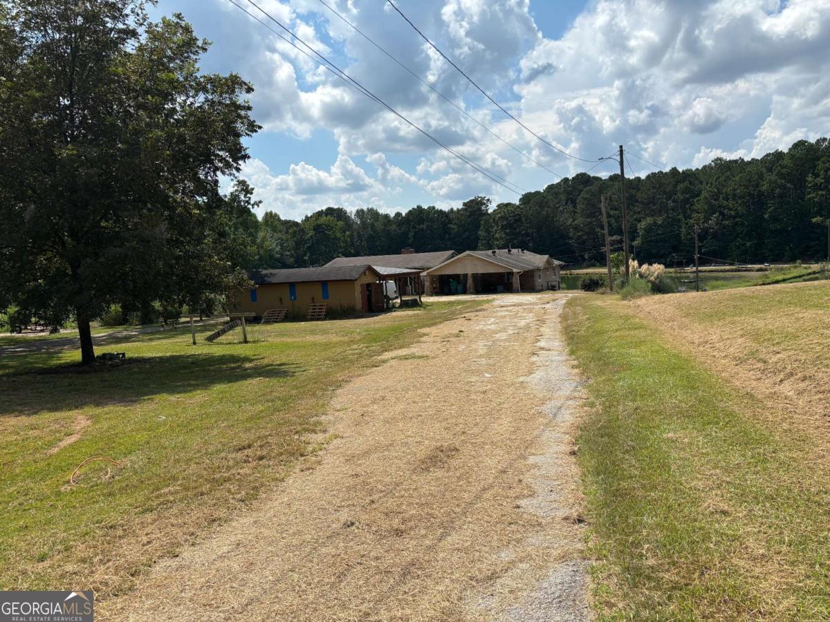 13+ acres - Lakefront opportunity!!! This spacious 5-bedroom, 3-bath home sits directly on the water, offering peaceful views and endless potential. With a little TLC, this property could be transformed into a stunning primary residence, a rental investment, or a profitable flip. The flexible floorplan and large lot provide plenty of options for updates and customization. Conveniently located near schools, shopping, and major highways.. Don't miss your chance to invest in lakefront living-schedule your showing today!