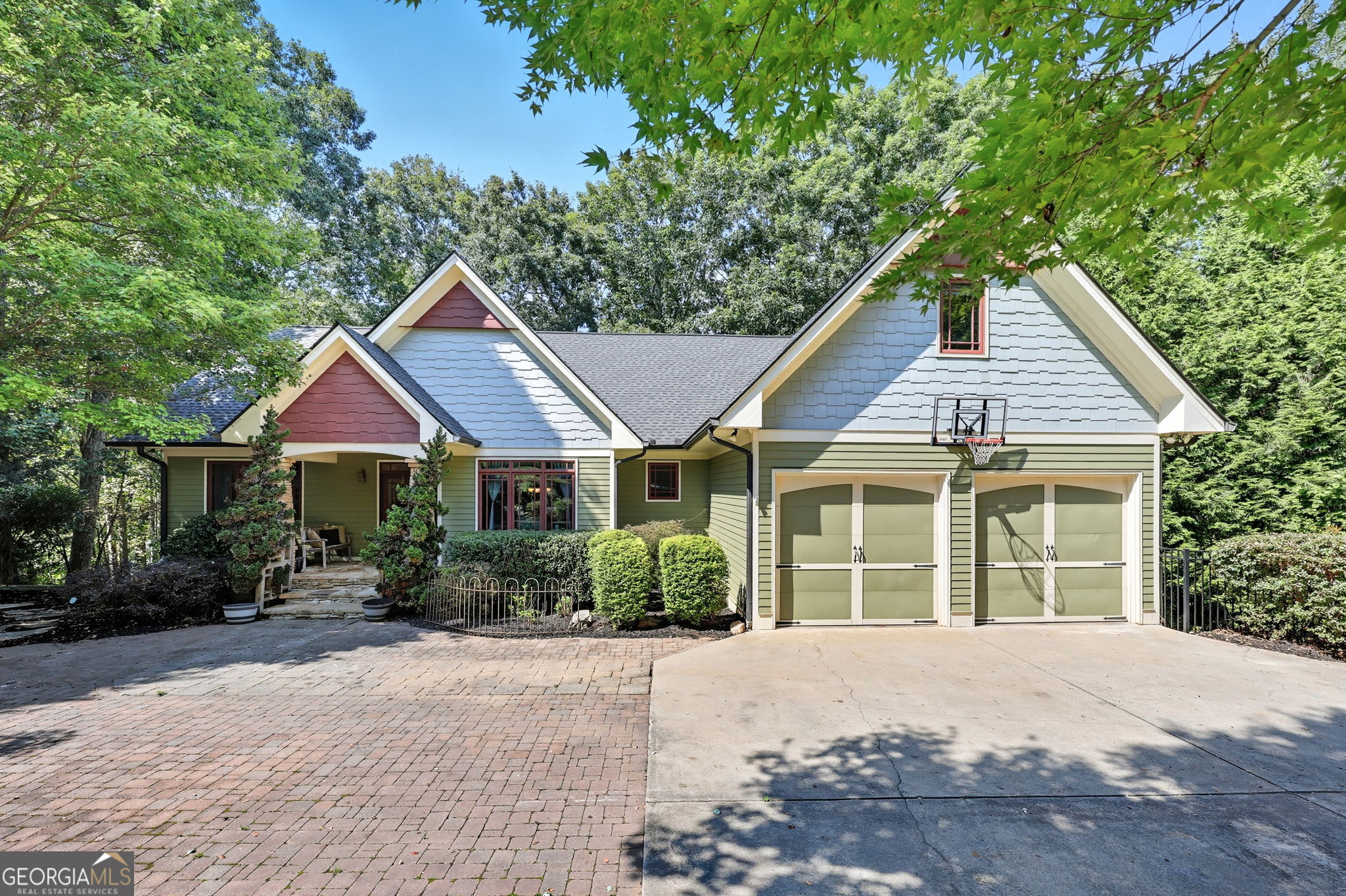 Welcome to this beautiful craftsman-style home with a charming cabin feel! Inside, you'll find warm, rustic finishes and plenty of flexible living space. Master is on Main, plus two additional bedrooms and a shared bath. An expansive deck with an outdoor fireplace creates the perfect spot for relaxing and enjoying seasonal views of Lake Lanier. Downstairs, the finished basement offers a media room with a closet and window that can serve as an additional bedroom, along with a large bonus room that can double as another sleeping space. With two full kitchens and two full laundry rooms-one on each level-this home is perfectly set up for a mother-in-law suite, multi-generational living, or extended guest stays. Outside, you'll find a picturesque koi pond and waterfall, adding to the home's serene ambiance. A private lower-level courtyard with a fire pit offers even more outdoor enjoyment. Plus, the property boasts a brand-new roof and has been meticulously maintained, making it move-in ready. To top it off, this home is nestled in a wonderful Lake Lanier community with a convenient boat ramp just around the corner, offering easy access to all the fun and recreation the lake has to offer.