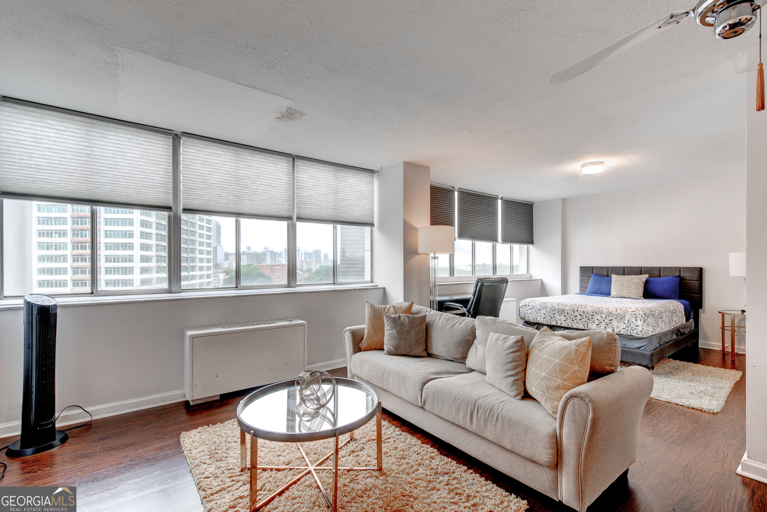 BRIGHT & SPACIOUS FURNISHED Studio with City Views in Downtown Atlanta - NO RENTAL RESTRICTIONS! Discover this large, CHARMING furnished studio that combines comfort, style, and UNBEATABLE location! Bathed in natural light with EXPANSIVE city views, this inviting space features an open layout, AMPLE STORAGE, and a BEAUTIFULLY renovated bathroom with a walk-in shower. The kitchen is well-appointed with stainless steel appliances, offering modern functionality for both short-term guests and full-time residents. Located just minutes from Georgia State University, Mercedes-Benz Stadium, Georgia World Congress Center, and Centennial Olympic Park, this unit places you in the heart of Atlanta's most iconic attractions. With EASY ACCESS to public transportation and major highways, getting around the city is effortless. Currently operating as an ACIVE Airbnb with a STRONG rental history, this property is being sold fully furnished, making it a TURN-KEY opportunity for investors or buyers seeking flexible use. With no rental restrictions, it can serve as a short-term rental, long-term investment property, or your own urban retreat. Don't miss your chance to own a stylish, income-producing studio in one of Atlanta's most desirable downtown locations!