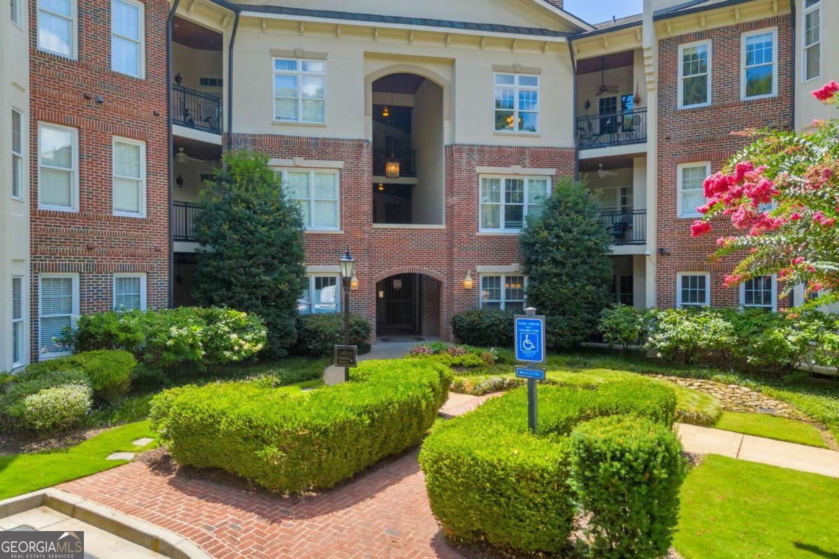 Nestled on the second floor of The Carlton, this 2-bedroom, 1-bath condominium offers an ideal blend of location and thoughtful upgrades. Step inside and enjoy over 1,000 square feet of living space with hardwood floors in the main living areas and luxury vinyl plank in the bedrooms-there is no carpet anywhere. The kitchen has been tastefully updated with light-gray cabinetry, a stylish backsplash, a modern sink and new lighting throughout the home. The bathroom renovation features a deep soaking tub and a separate tiled shower with a glass enclosure, complemented by a contemporary double vanity and tile floors. An upgraded HVAC system adds efficiency and comfort. The open-concept living and dining area centers on a fireplace, creating a warm ambiance. Doors from both bedrooms lead to a covered patio overlooking the community's quiet dog park-perfect for relaxing outdoors. Additional conveniences include a laundry room, pantry and included all appliances included. A dedicated covered, gated parking garage along with outdoor parking spots and a separate storage unit accompany the home. This condo makes the most of its footprint; carefully chosen finishes lend an expansive feel. The Carlton's amenities include a swimming pool just steps from the elevator, and its location is only minutes' walk to Ponce City Market and the Beltline. With most furnishings available for those who wish, this residence provides turnkey convenience and style.