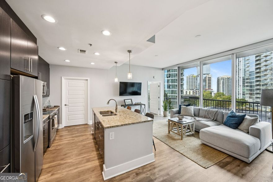 Stunning Midtown Condo with Panoramic City Views! Experience the Best of Intown Living at 1010 Midtown -- one of Atlanta's most sought-after luxury high-rises! This Spacious Residence showcases Floor-to-Ceiling Windows framing Breathtaking Skyline Views and a Private Balcony perfect for morning coffee or evening entertaining. Step inside to find an Open-Concept Layout featuring a Chef's Kitchen with Granite Countertops, Stainless Steel Appliances, and Rich Cabinetry flowing seamlessly into the Light-Filled Living Room. Enjoy thoughtful upgrades throughout, including New Hardwood Flooring, Motorized Solar Shades, and Custom Solid Wood Cabinetry in both the Kitchen and Bathrooms. The Primary Suite offers serene views, Balcony Access, and a Spa-Like Bathroom with Dual Vanities, a Soaking Tub, a Separate Glass Shower, and Walk-In Closet. A Second Bedroom with Floor-to-Ceiling Windows and an adjacent Full Bathroom provides the perfect space for guests or a Home Office, while In-Unit Laundry adds everyday convenience. Elevate your lifestyle with Resort-Style Amenities a Heated Pool with Skyline Views, a State-of-the-Art Fitness Center with Peloton Bikes, a Club Room with Catering Kitchen and Billiards, Outdoor Grilling Areas, and 24-Hour Concierge Service. Two Designated Gated Parking Spaces add ease and peace of mind. Located along the Iconic Peachtree Curve, you'll be just steps from Piedmont Park, The BeltLine, Colony Square, The High Museum, Fox Theatre, Whole Foods, and Atlanta's Best Dining and Shopping. Enjoy Luxury Living in the Heart of Midtown where stunning views meet unmatched convenience and style.
