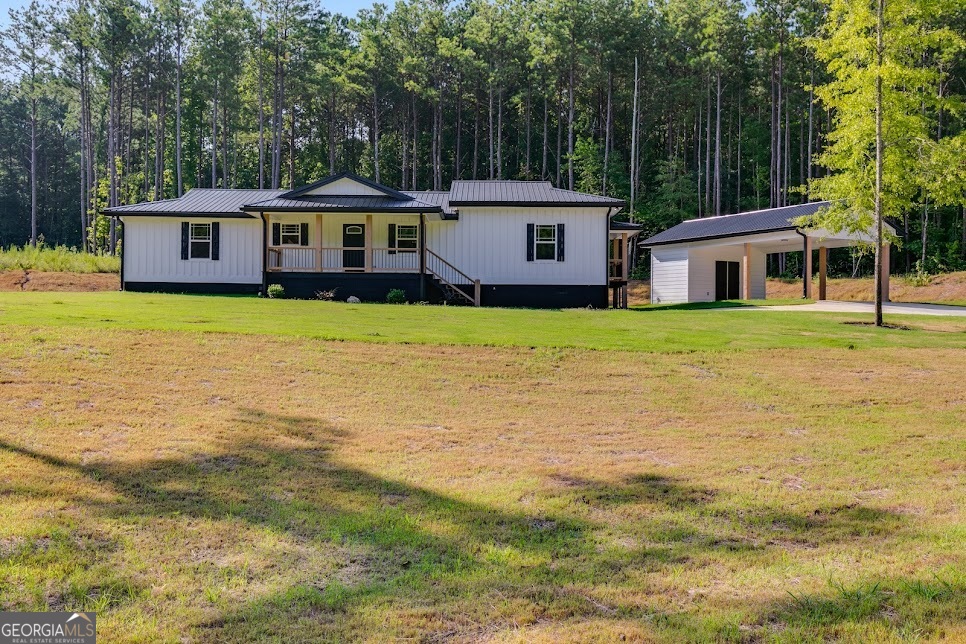 This 3 Bed 2 Bath Ranch home has been completely remodeled down to the studs with above builder-grade materials! The only thing original to the house is the frame. New Everything! The house is sitting on just over 1 acre, located 1.5 miles from Ephesus Elementary School. It has a custom detached carport/storage room. Brand new custom cabinets, granite countertops, and new stainless steel appliances. Hardwood and tile floors throughout. Metal roof and spruce wood siding. Custom walk-in shower and jacuzzi tub in the master bedroom alongside a large walk-in closet and a private walk-out porch. Laundry room. Covered front and back porches along with a Master bedroom balcony. Newly poured concrete. All Electric. The home is around 20 mins from Carrollton. Schedule your viewing today! 1 Year Builders Warranty included!