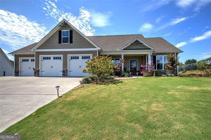 Discover a truly one-of-a-kind home that blends thoughtful design, modern comfort, and timeless character. Only five years old, this beautifully crafted residence showcases numerous upgrades, including rich engineered hardwood floors, a whole-home attic fan, and an oversized three-car garage-with two bays extended to 24.5 feet deep for added versatility. The open-concept floor plan is a showstopper, featuring a stunning kitchen with stainless steel appliances, an expansive bar with seating, and generous workspace for the home cook or advanced chef. It seamlessly flows into the main living areas, making it ideal for entertaining and everyday living. The inviting master suite is a retreat of its own, highlighted by a 150-year-old cast iron soaking tub and a custom-tiled shower. Upstairs, a spacious bonus room above the garage offers endless possibilities, including the potential for an additional bath. Set gracefully on a manicured cul-de-sac lot, this craftsman-style home enjoys an elevated presence framed by fruit trees, berry trellises, and lush landscaping. Step outside to a 12x16 covered patio-perfect for morning coffee or evening gatherings. Every detail of this home was thoughtfully considered to create comfortable, efficient living, and now it's ready to welcome its next owners. Don't miss this rare opportunity-homes like this are a true find.