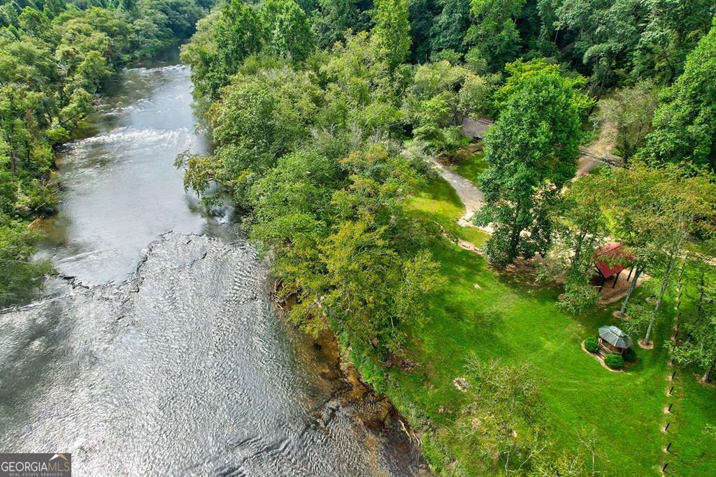 This is a rare and extremely limited opportunity-only one lot remains available in the highly sought-after Gated River Ridge on the Toccoa community! This exceptional 4.04-acre parcel offers the perfect combination of privacy, natural beauty, and convenience, just 4 miles from Downtown Blue Ridge and five minutes from Old Toccoa Golf Course. Located near the main gate, it provides quick access and a peaceful and private setting. Imagine building your dream home on this expansive, gently rolling landscape with mature trees, a natural spring, and a quiet stream that begins right on the property. The lot is a 'cuddle sac'-tucked away in a serene area with complete privacy and no through traffic. It flows seamlessly to the well-maintained community river access, offering excellent opportunities for fishing, tubing, kayaking, or simply relaxing by the water. The subdivision has been approved and is moving forward with paving, with utilities already in place, making it easy to develop your perfect mountain retreat with modern comforts. Backing directly to Old Toccoa Golf Course, this location boasts stunning views and easy access to the course. The community amenities include a pavilion, picnic areas, and a charming gazebo-perfect spots for outdoor gatherings or quiet reflection. Whether you're seeking a primary residence, vacation home, or short-term rental investment, this property truly has it all, offering proximity to shopping, dining, outdoor adventures, and the tranquil mountain scenery of Blue Ridge. Properties like this are extremely limited-this is your last chance to own in this exclusive, amenity-rich neighborhood. With incredible privacy, natural beauty, and a prime location, it's a rare opportunity that won't last long. Act quickly-reach out today and make this extraordinary property yours before it's gone! And Blue Ridge itself offers a vibrant, charming small town atmosphere with fine dining, unique shops, outdoor attractions, and endless adventures.