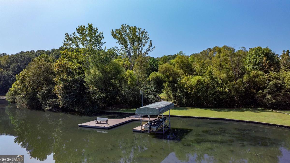 Discover the perfect fisherman's retreat at 1571 Indian Woods Drive on Lake Oconee. Fully renovated and move-in ready, this home sits on a spacious double lot with a two-story barn and fruit trees, including muscadines, pears and plums. A peaceful walkway leads to your private dock, ideal for fishing or enjoying the water. Meticulously maintained and offered furnished, this turnkey property makes lake living simple and stress-free.