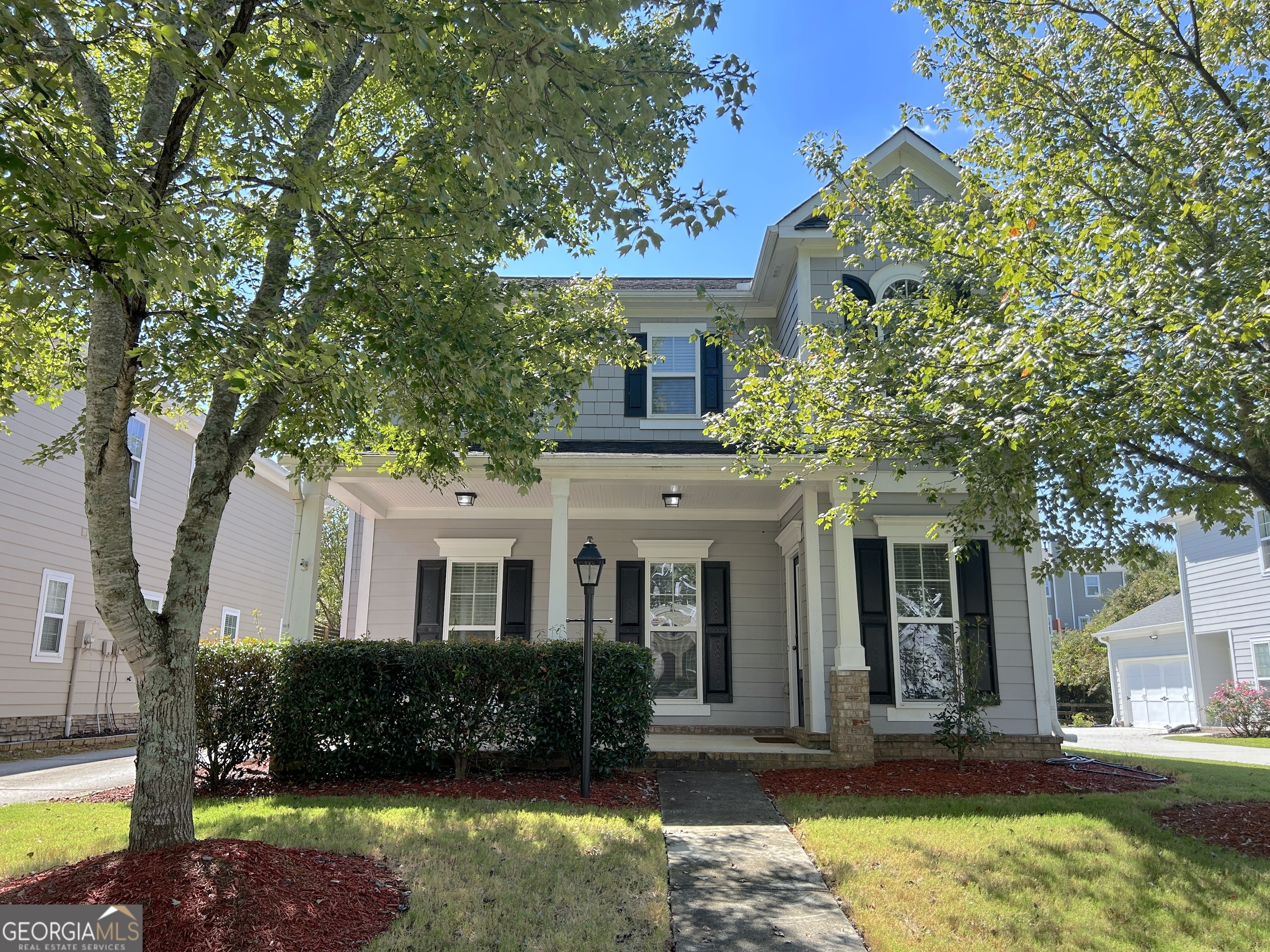 Greet your friends and sit awhile on the inviting rocking chair front porch of this craftsman beauty. This charming stunner is nestled in a highly desirable swim/tennis community within the sought-after school district of Burnett Elementary, Hull Middle, and Peachtree Ridge High School. You'll love the welcoming two-story entryway and large windows that fill the home with natural light. The bright and open layout is perfect for entertaining. At the heart of the home is a beautiful gourmet kitchen, complete with stainless steel appliances, a pantry, breakfast bar, and an open view to the spacious fireside family room. The highlight of the family room is a wood-burning fireplace with a gas starter-rare in newer homes and perfect for cozy nights. Upstairs, escape to your dream master bedroom, boasting tray ceilings and a large walk-in closet. The luxurious master bath features dual vanities, a separate shower, and a soaking tub. Two additional ample-sized bedrooms and a full bath complete the upper level. Your loved ones will enjoy the spacious, fully fenced backyard-a rare feature in this community-perfect for pets and gatherings. This home also features: A whole-house water filtration system for cleaner, fresher water. A Samsung high-quality washer and dryer, included with the sale. Community amenities include a swimming pool, tennis courts, pickleball courts, a large clubhouse, and a fitness center. The location is unbeatable- short distance to restaurants, grocery stores, and shops. Don't miss your opportunity to write your next chapter in this beautifully maintained craftsman home!