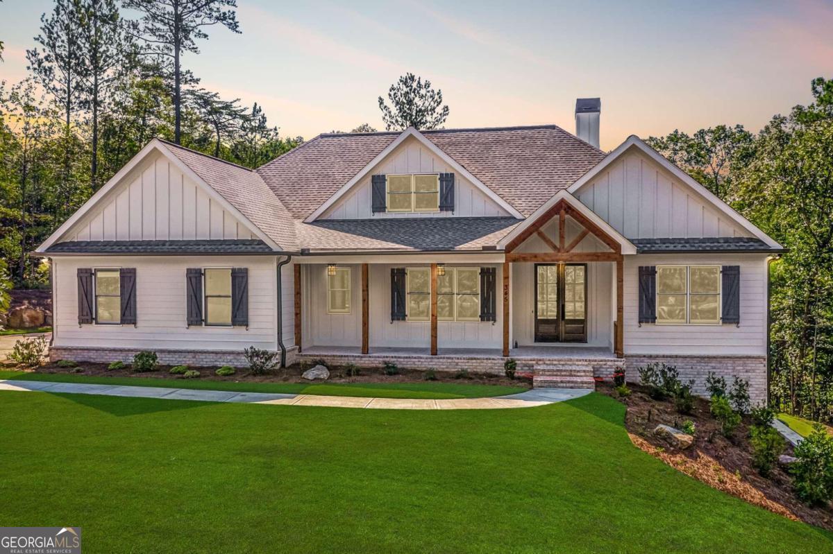 Gorgeous custom ranch in Cherokee County - and it's move in ready! This home sits on almost an acre with a nice, long driveway and features an open concept floor plan, a brick front porch, beautiful hardwood floors, coffered ceilings and built-in shelving in the living room, extra trim features throughout the home, a large island in the kitchen, a walk-in pantry, tons of counter and cabinet space, upgraded appliances fit for someone who loves to cook (including a gorgeous 48" double oven cooktop and pot filler), quartz countertops, two master closets, 8 ft' doors in the living room that will open the home up to the back porch (perfect for entertaining), almost 800 square feet of screened on porch, tongue and groove porch ceilings, an outdoor fireplace, a full basement ready to be finished for additional living space if needed, and so much more! Be sure to check out the virtual tour! The builder has also added custom shelving in the master closets, ship lap above the master bathroom vanities and a glass shower door in the secondary bathroom! **GPS MAY NOT PICK UP ON MASONS WAY YET - PLEASE SEE USE 1005 CABLE RD WALESKA 30183 JUST FOR GPS PURPOSES IF NEEDED**
