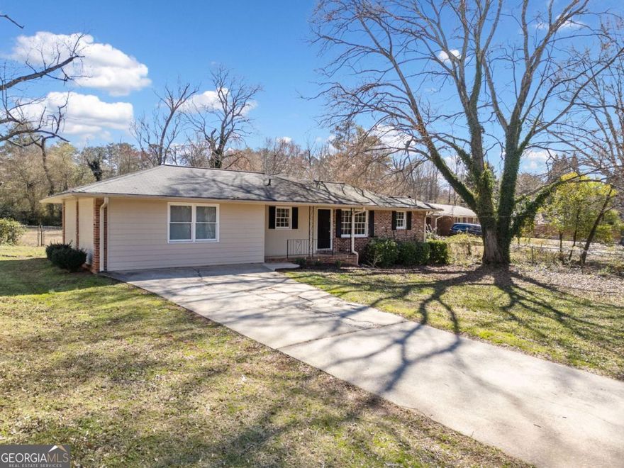 Welcome to this charming, Ranch home located in the highly desirable Lassiter school district. This home boasts a traditional floorplan with beautiful hardwood floors and neutral paint throughout. As you enter, you are greeted by a spacious Living room with access to a cozy Den, perfect for a home office or reading nook.  The open concept kitchen features stainless steel appliances, well-maintained original cabinets, and ample built-in storage. The laundry area is conveniently located off the kitchen for added convenience. The home offers 3 bedrooms, all with hardwood flooring and neutral paint, providing a warm and inviting atmosphere.  Step outside to the HUGE yard, perfect for entertaining or simply relaxing in the peace and quiet. The carport has been converted into additional Living Space, adding versatility to the home.  Don't miss out on the opportunity to make this lovely home yours. Schedule a showing today and experience all that this charming Ranch home has to offer!