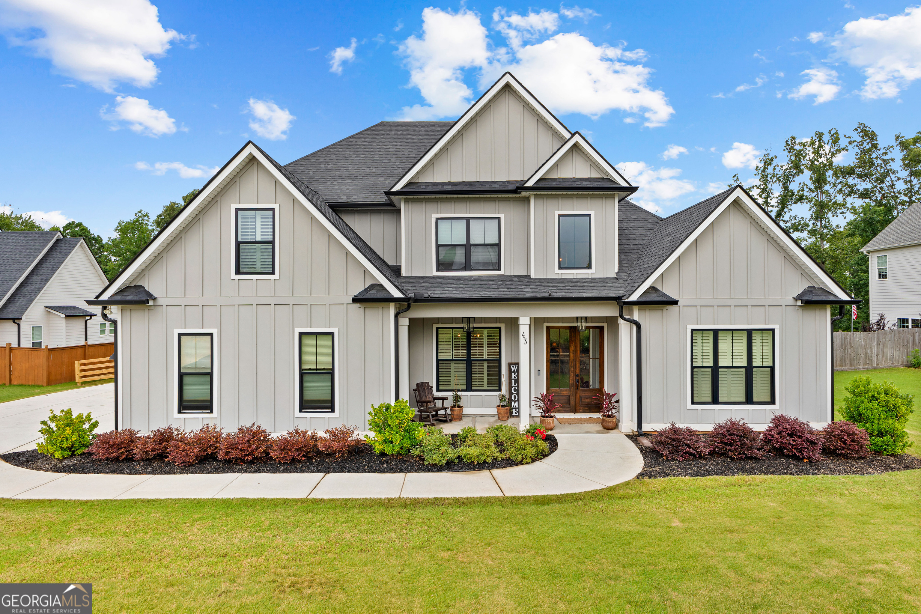 Beautifully crafted home in Northshore at Lake Redwine. Dramatic double-door entrance opens to a wide foyer with elevated ceilings and large windows flooding the home with natural light. Gourmet kitchen beautifully appointed with stainless steel appliances, a large island, custom cabinetry, quartz countertops, and a large walk-in pantry. The great room is the heart of the home featuring a stone gas fireplace, expansive windows, and opens out to a covered porch that has a fireplace perfect for indoor/outdoor entertaining. Luxury owner's suite located on the main level, with tray ceilings, dual vanities, soaking tub, and a separate tiled shower. Upstairs you will find three additional bedrooms including a Jack and Jill configuration, one bedroom with its own private bath, plus a loft/media or office space. Elegant hardwood flooring throughout the main level, premium trim and finish work. Three car garage provides ample parking and storage. Fully fenced backyard combining privacy and outdoor enjoyment. Located in Northshore at Lake Redwine, a sought-after community. Enjoy abundant amenities: boating, fishing, swimming pool, pool with splash pad, lighted tennis and racquetball courts, playgrounds, sidewalks, and well-lit streets.