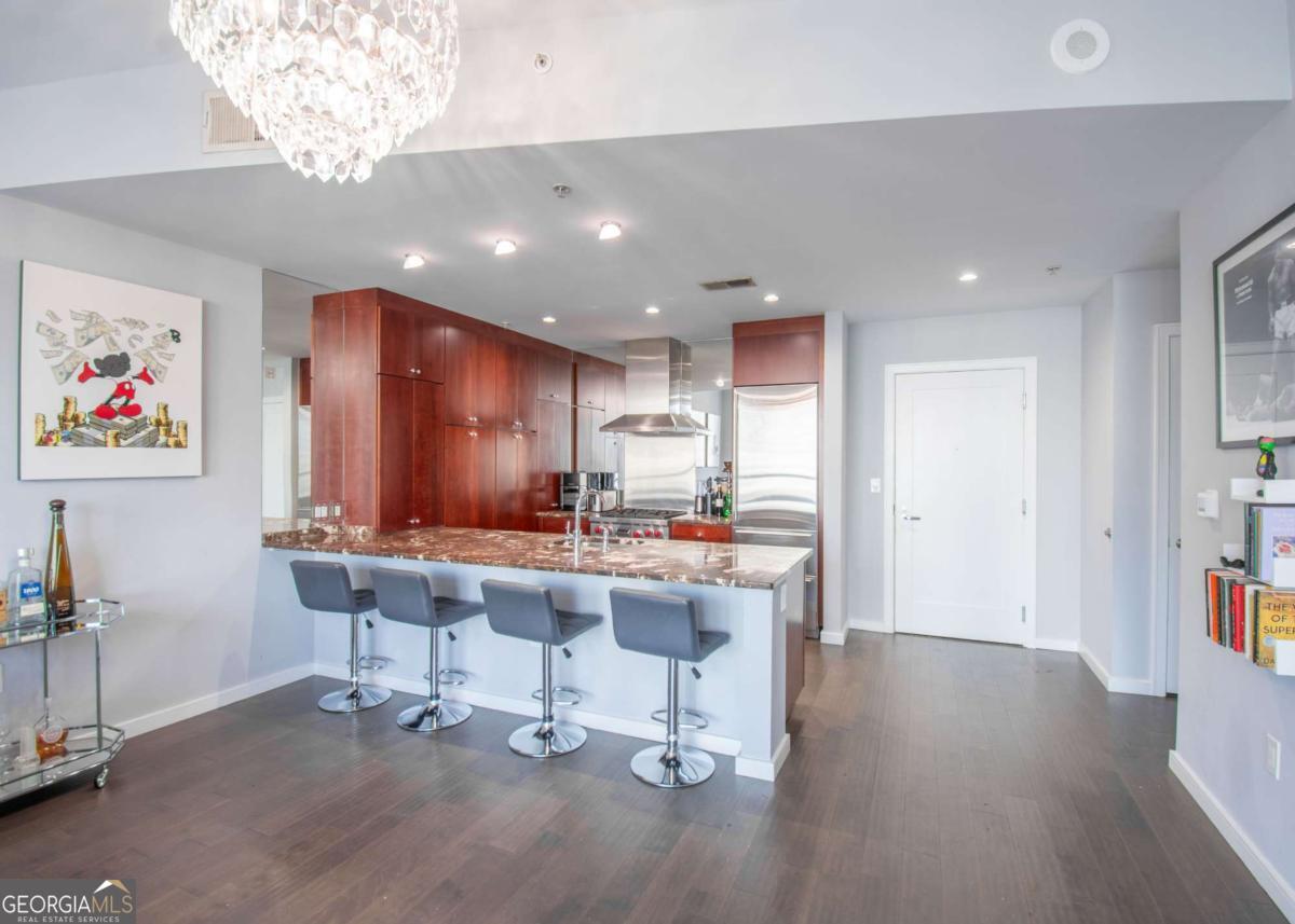 Welcome to Buckhead living at its finest! This stunning 1-bedroom, 1-bath condo in the prestigious Terminus building offers breathtaking skyline views and a modern, open-concept design perfect for both everyday living and entertaining. Inside, you'll find floor-to-ceiling windows flooding the home with natural light, sleek hardwood floors throughout, and a chef's kitchen complete with high-end appliances, stone countertops, and an oversized island. The spacious primary suite features a spa-like bath with dual vanities, a soaking tub, and a walk-in shower. The secondary bedroom is equally inviting, perfect for guests or a home office. Enjoy world-class amenities, including 24-hour concierge service, fitness center, resort-style pool, valet parking, club room, and guest suites. Step outside and experience the very best of Buckhead-award-winning restaurants, luxury shopping, and vibrant nightlife, all just moments from your door. With its unbeatable location, sophisticated finishes, and resort-style amenities, this home offers the ultimate lock-and-leave lifestyle in one of Atlanta's most coveted addresses.